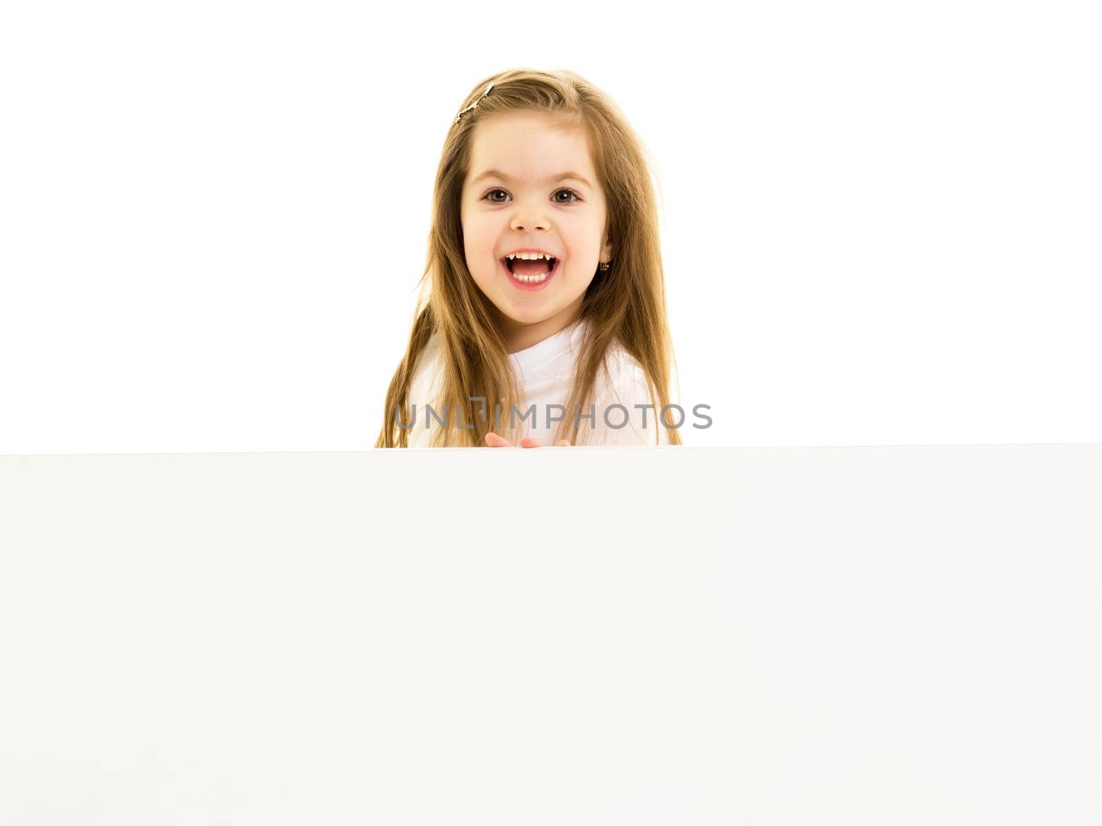 A nice little girl screams. The concept of emotions, advertising. Isolated on white background.