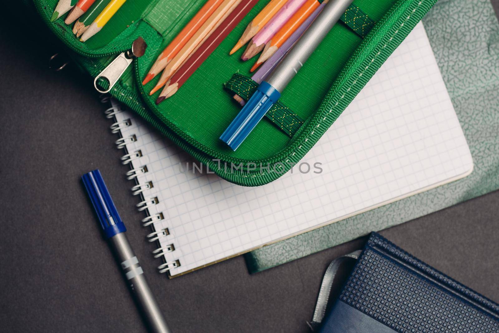 green pencil case with pencils design object school supplies. High quality photo