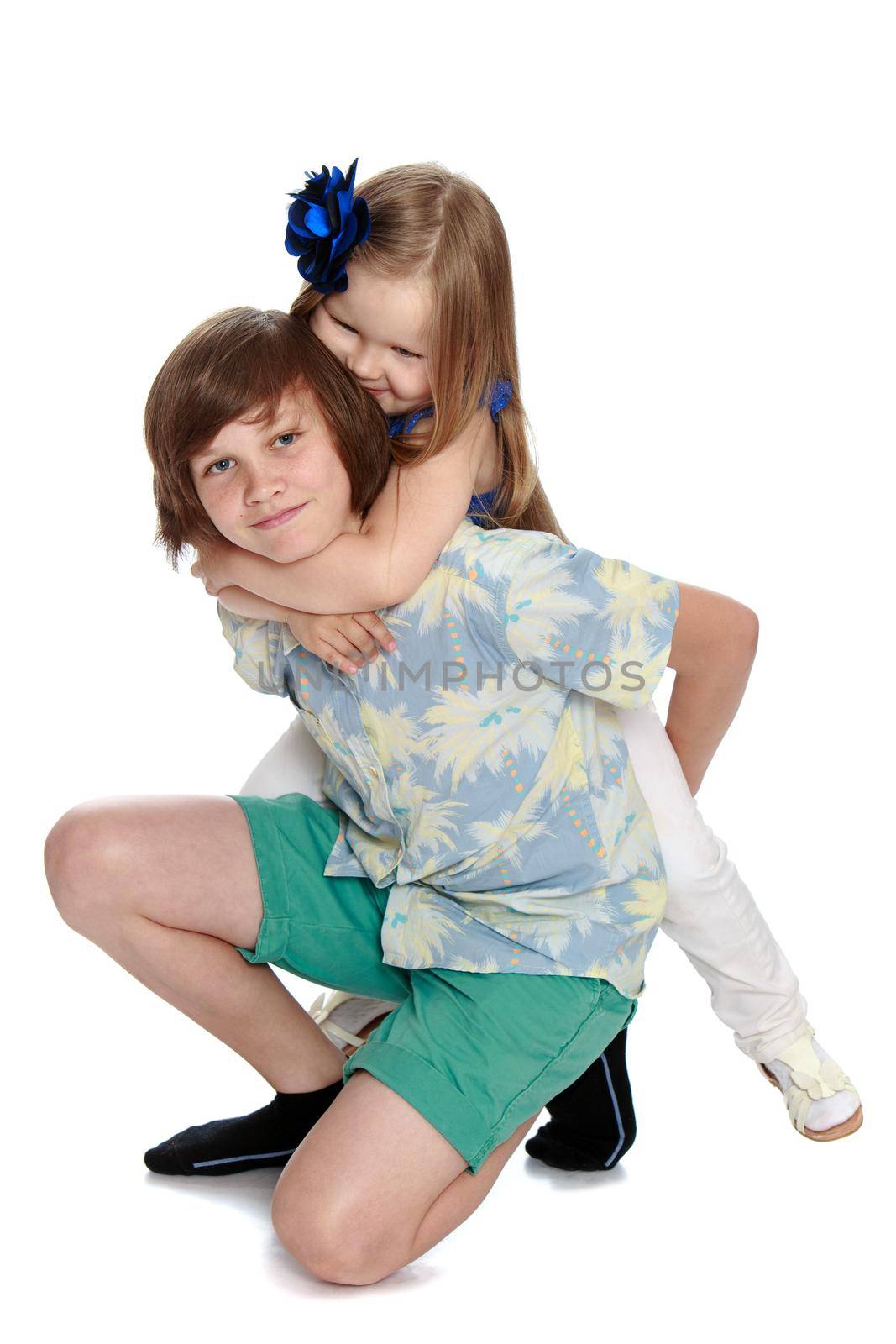 Gentle little girl hugging his neck of his older brother - Isolated on white background