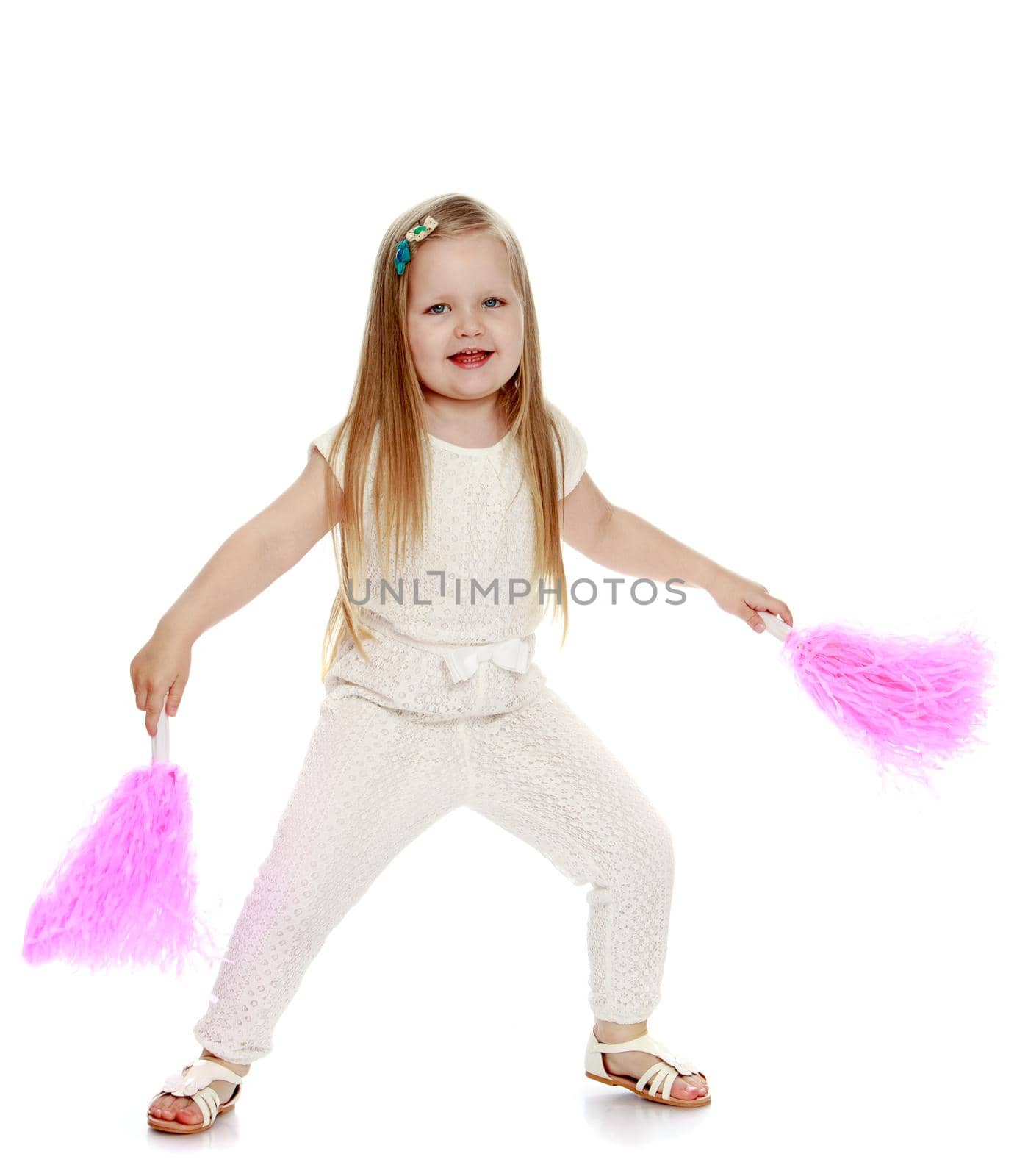 Beautiful little girl with long blond hair below the shoulders , in white overalls , waving pink tinsel - Isolated on white background