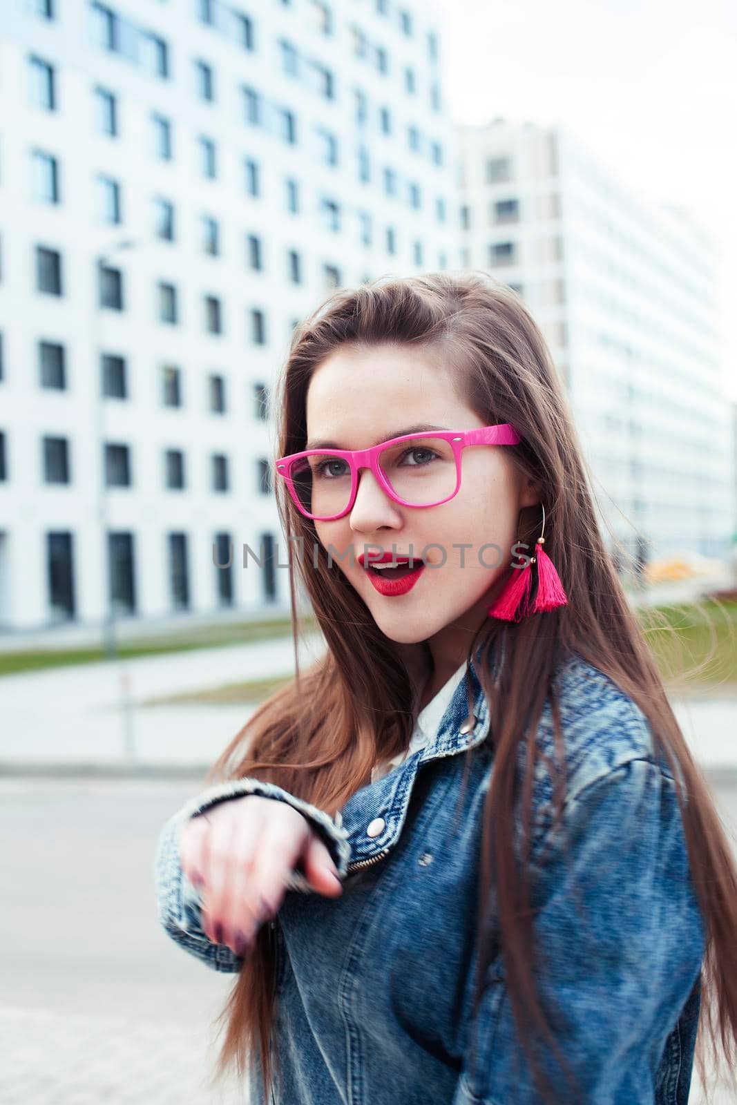 young pretty brunette business woman posing against modern building in glasses holding coffee, lifestyle people concept close up