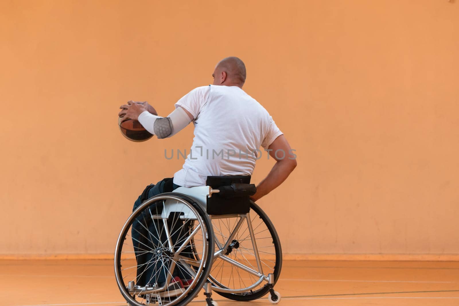 disabled war veterans in action while playing basketball on a basketball court with professional sports equipment for the disabled by dotshock