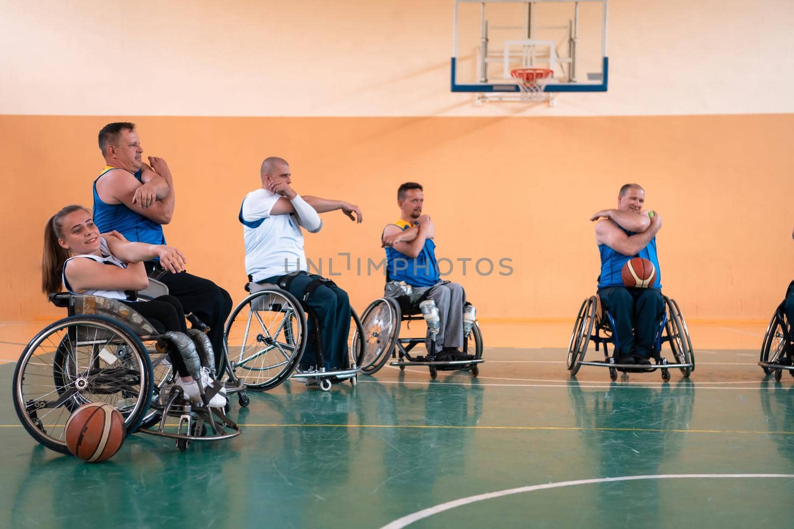 teams of basketball teams with disabilities warm up and do stretching exercises before training begins by dotshock