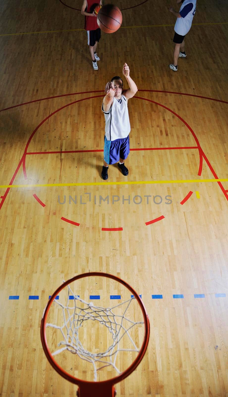 basketball game playeer shooting on basket indoor in gym