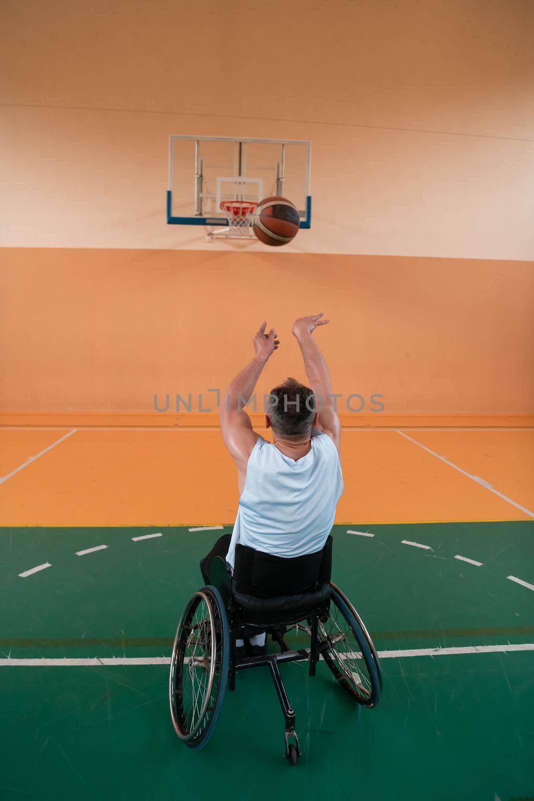 a photo of a war veteran playing basketball in a modern sports arena. The concept of sport for people with disabilities. High quality photo