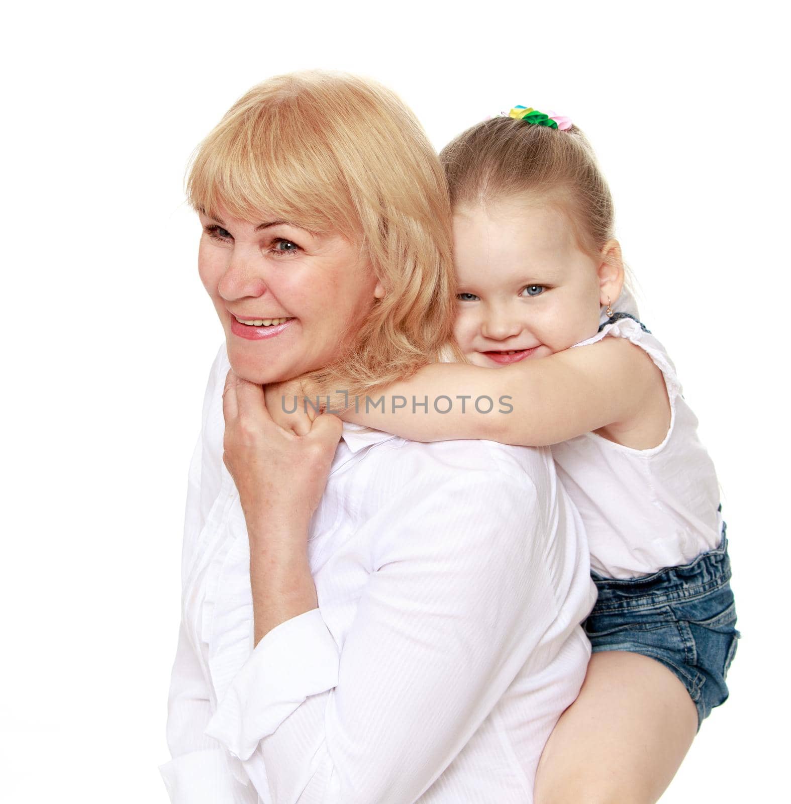 Happy little girl riding on the back of his grandmother - Isolated on white background
