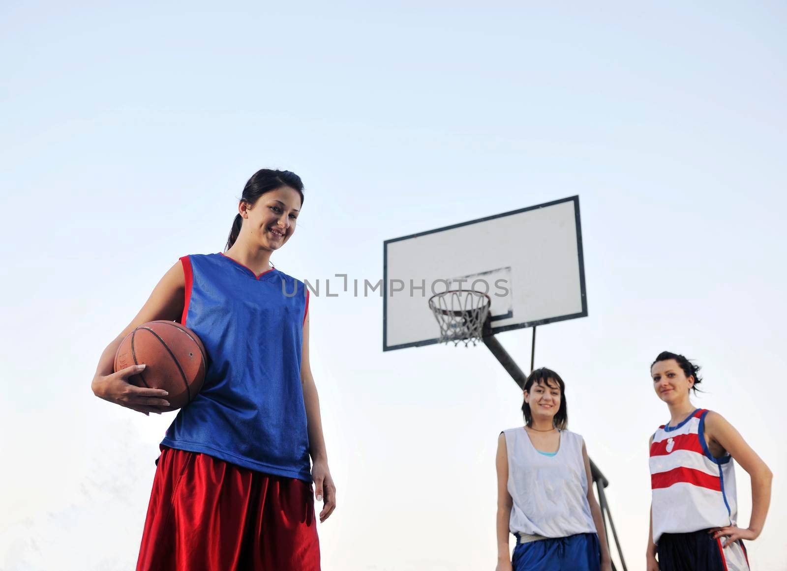 woman basketball player have treining and exercise at basketball court at city on street