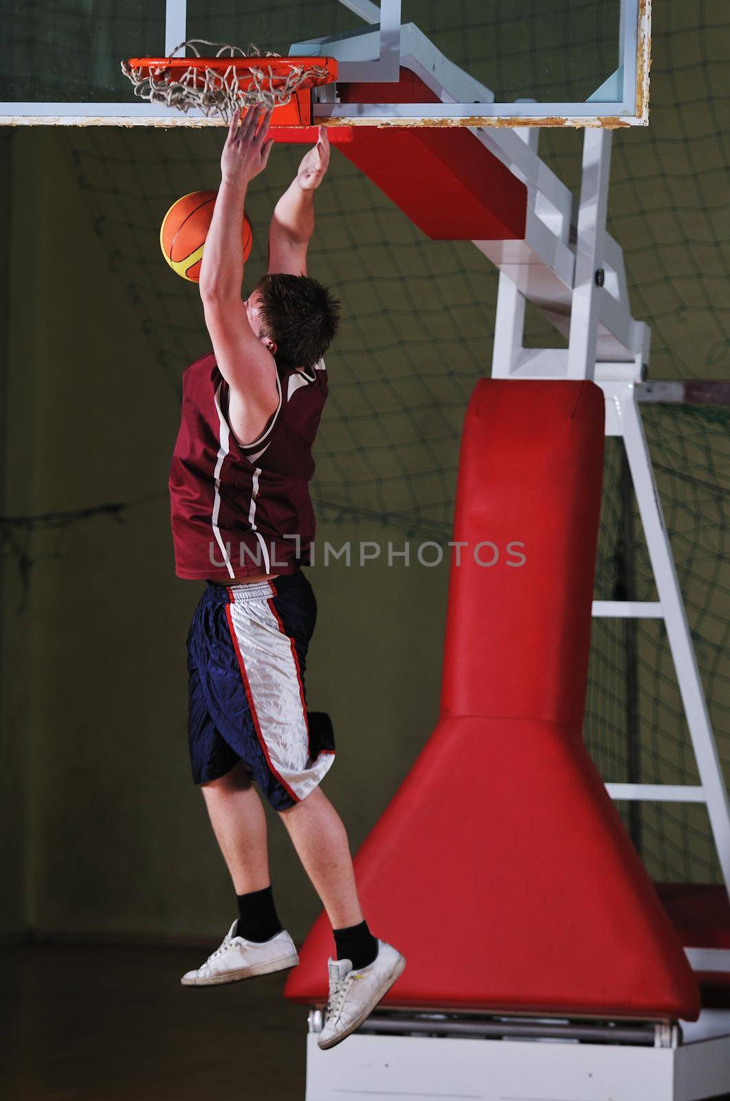 basket ball game player at sport hall by dotshock