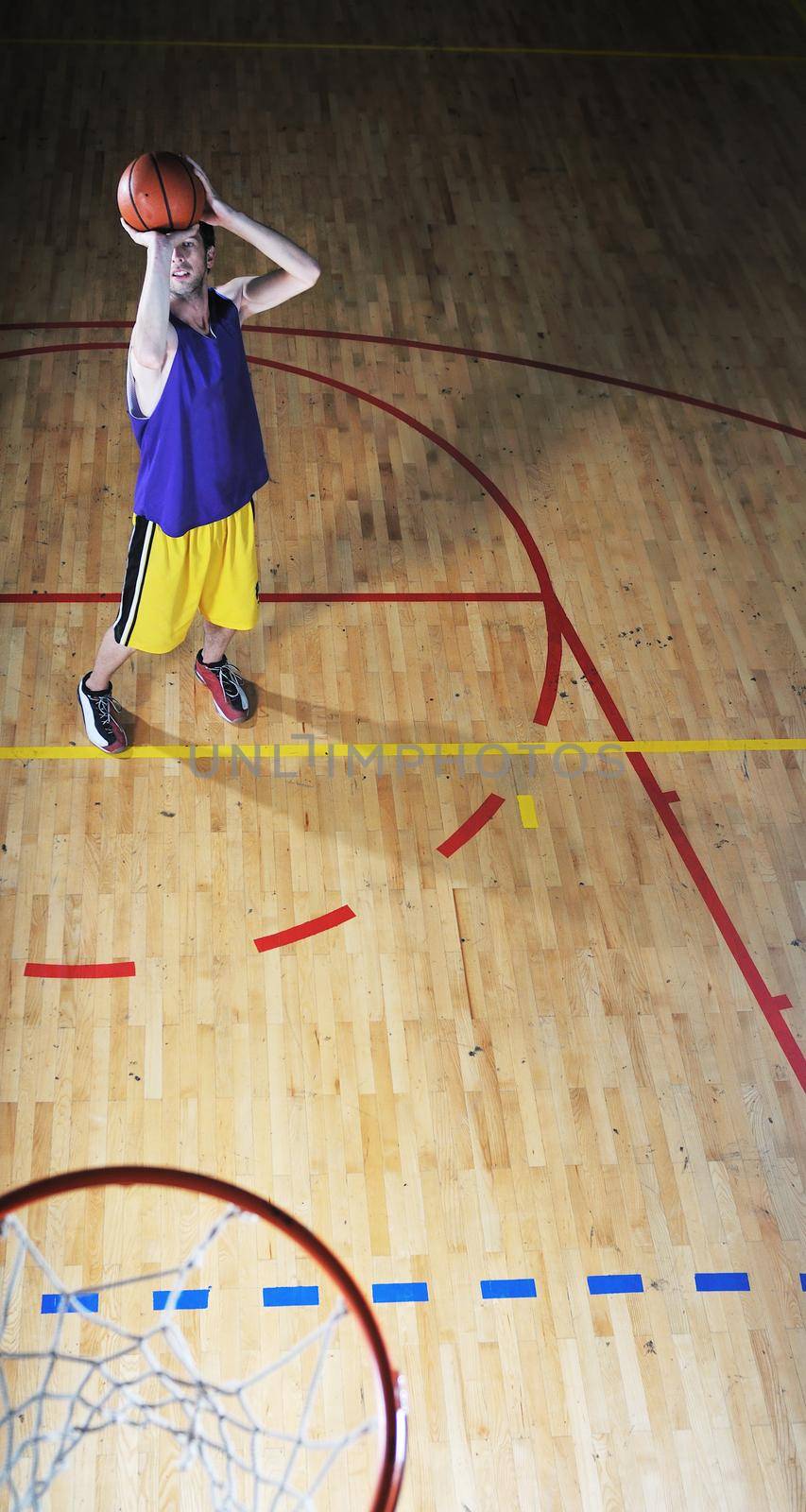 one healthy young  man play basketball game in school gym indoor