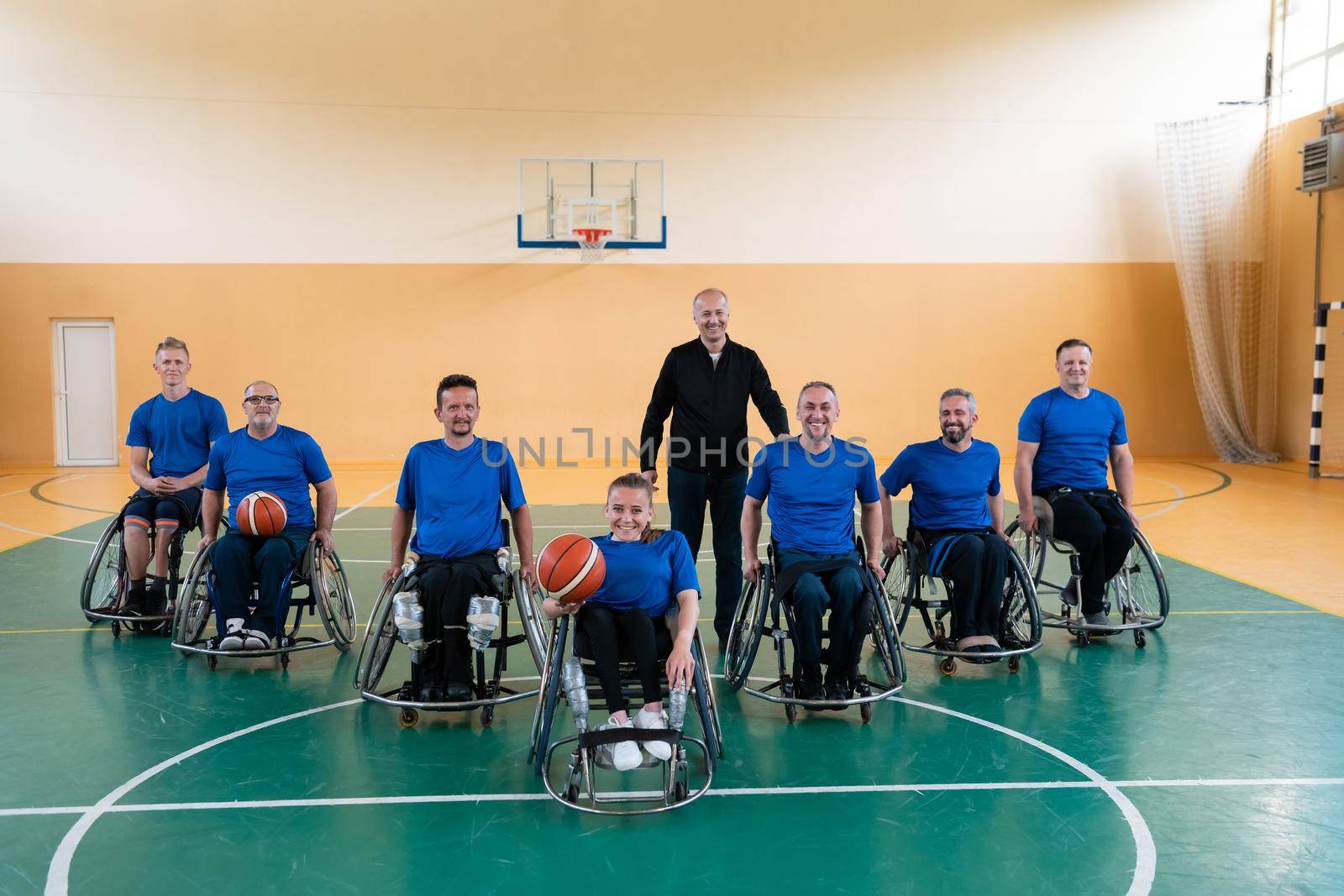 photo of the basketball team of war invalids with professional sports equipment for people with disabilities on the basketball court by dotshock