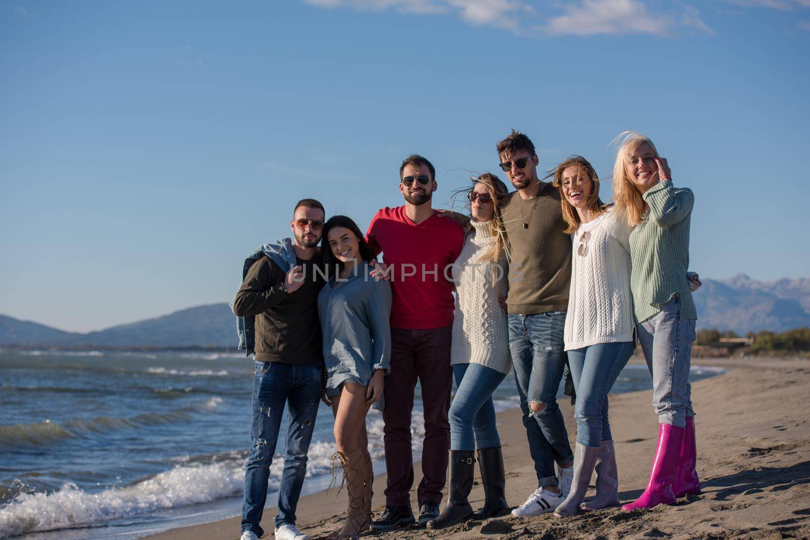 portrait of group Friends Spending The Day On A Beach during autumn day