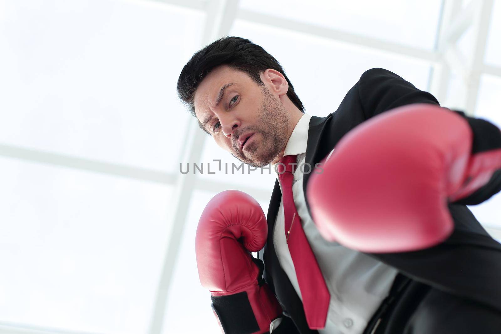 close up.a serious businessman in red Boxing gloves .photo with copy space