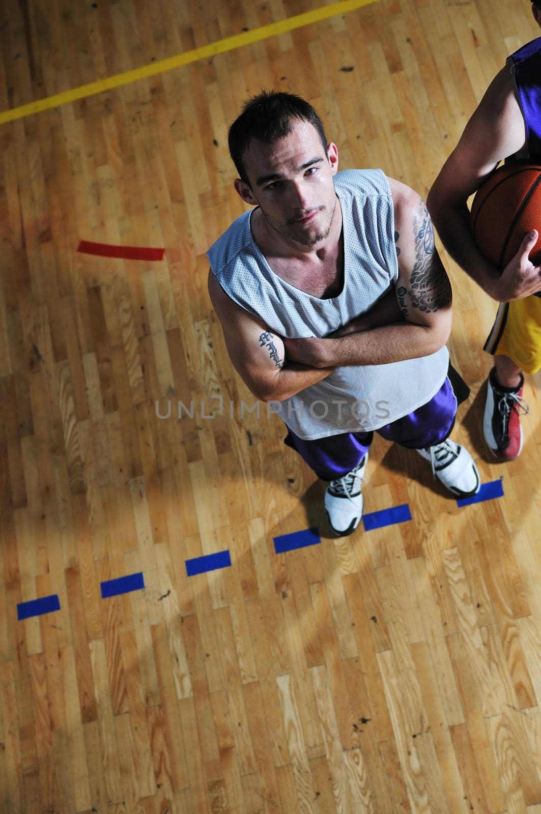 one basket ball game player standing in sport gym with ball