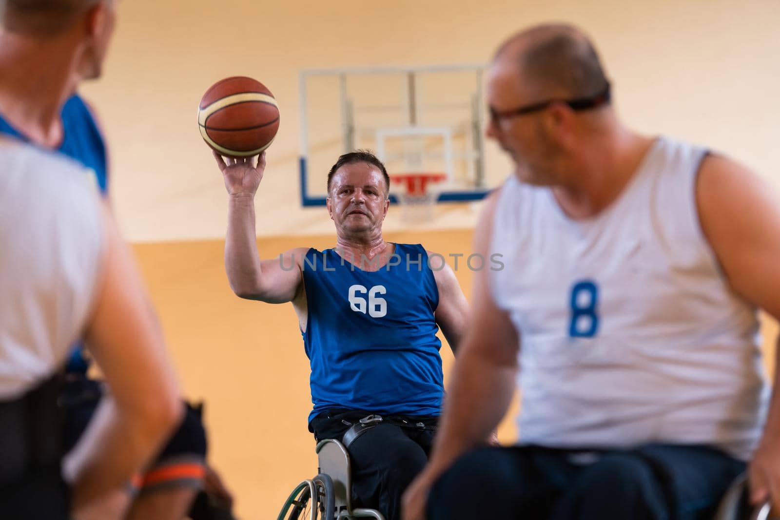 handicapped war veterans in wheelchairs with professional equipment play basketball matches in the hall. the concept of sports with disabilities. High quality photo