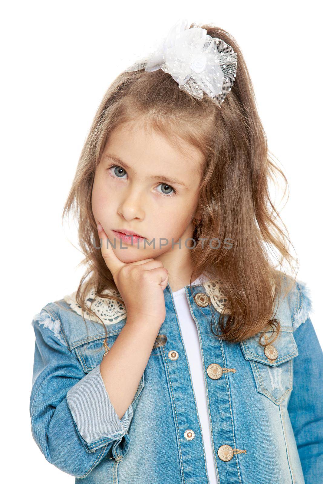 Portrait of shy little girl in denim suit. The girl about something thinks . close-up - Isolated on white background
