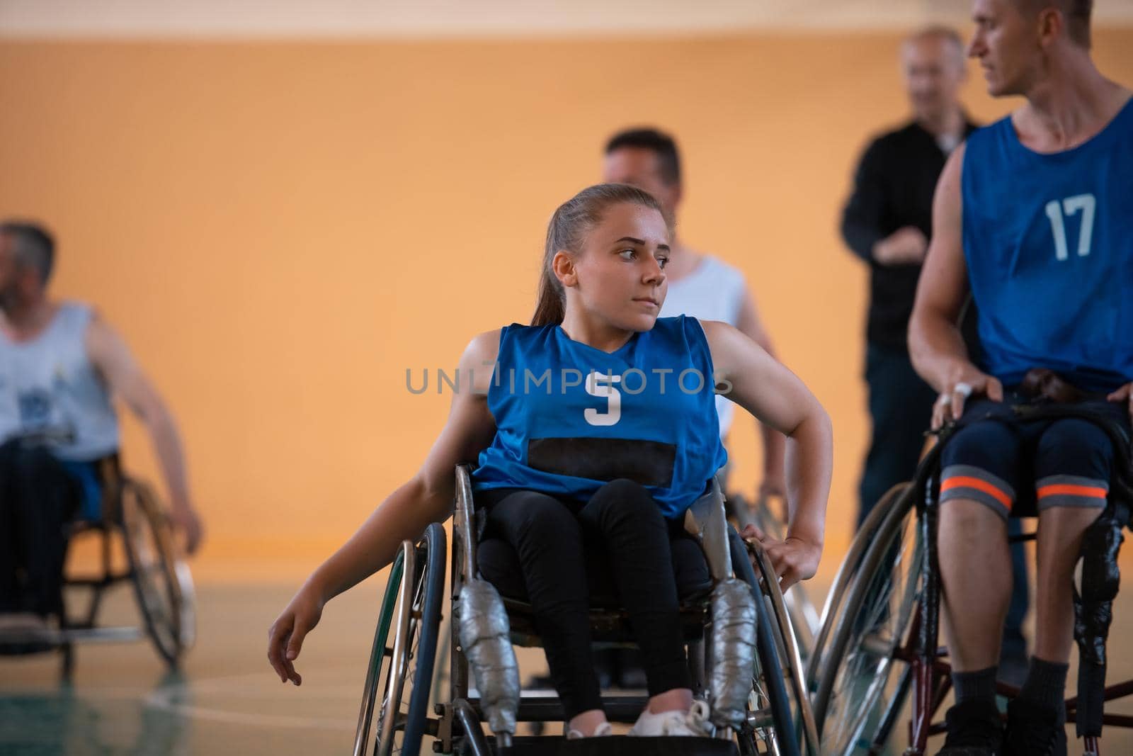 a young woman playing wheelchair basketball in a professional team. Gender equality, the concept of sports with disabilities.  by dotshock