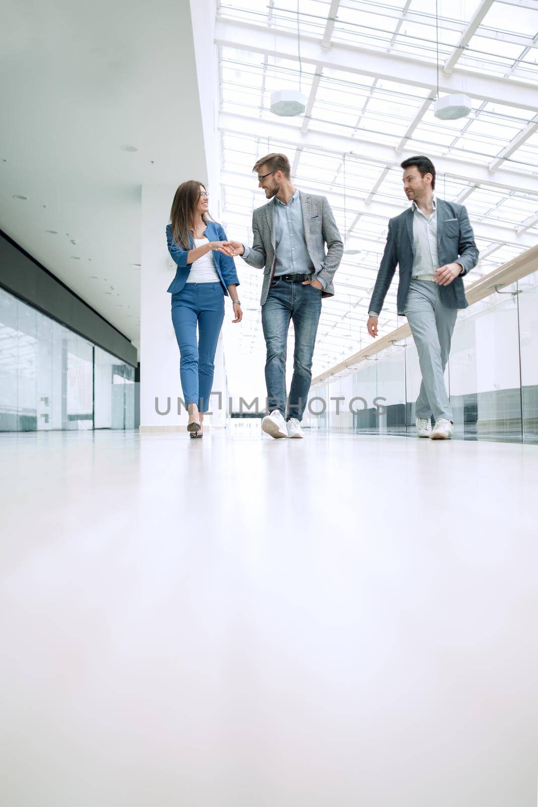 employees greet each other in the office building by asdf