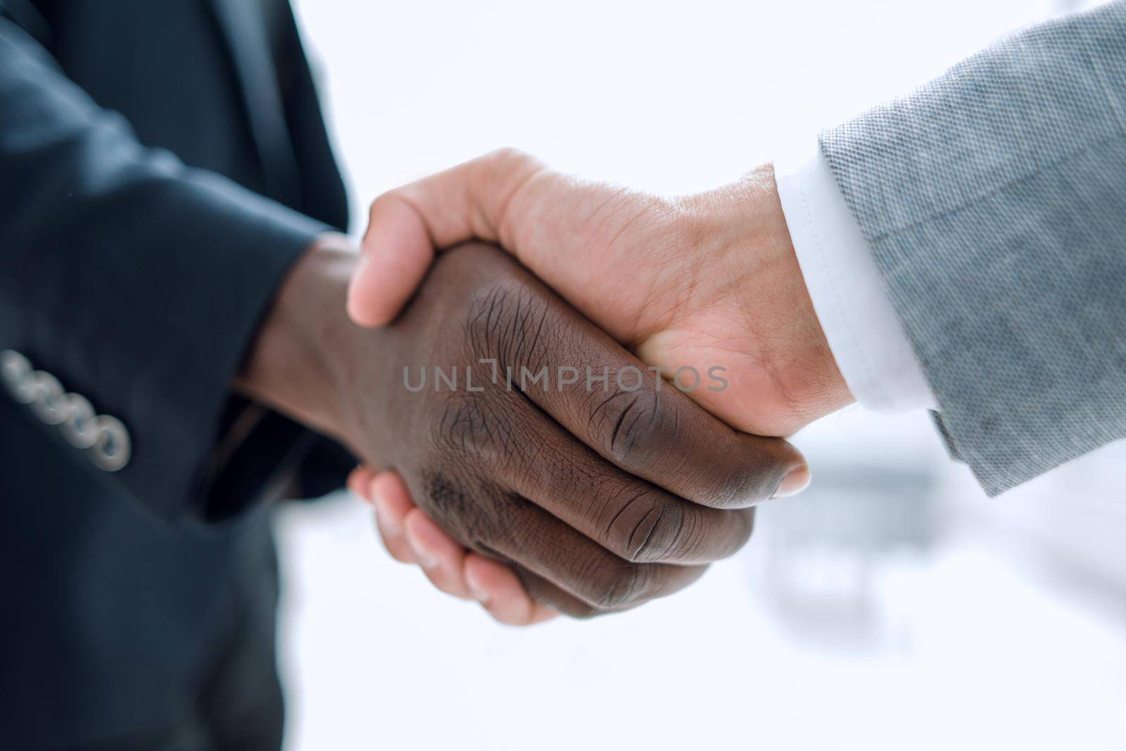 Business handshake in lofty office by asdf