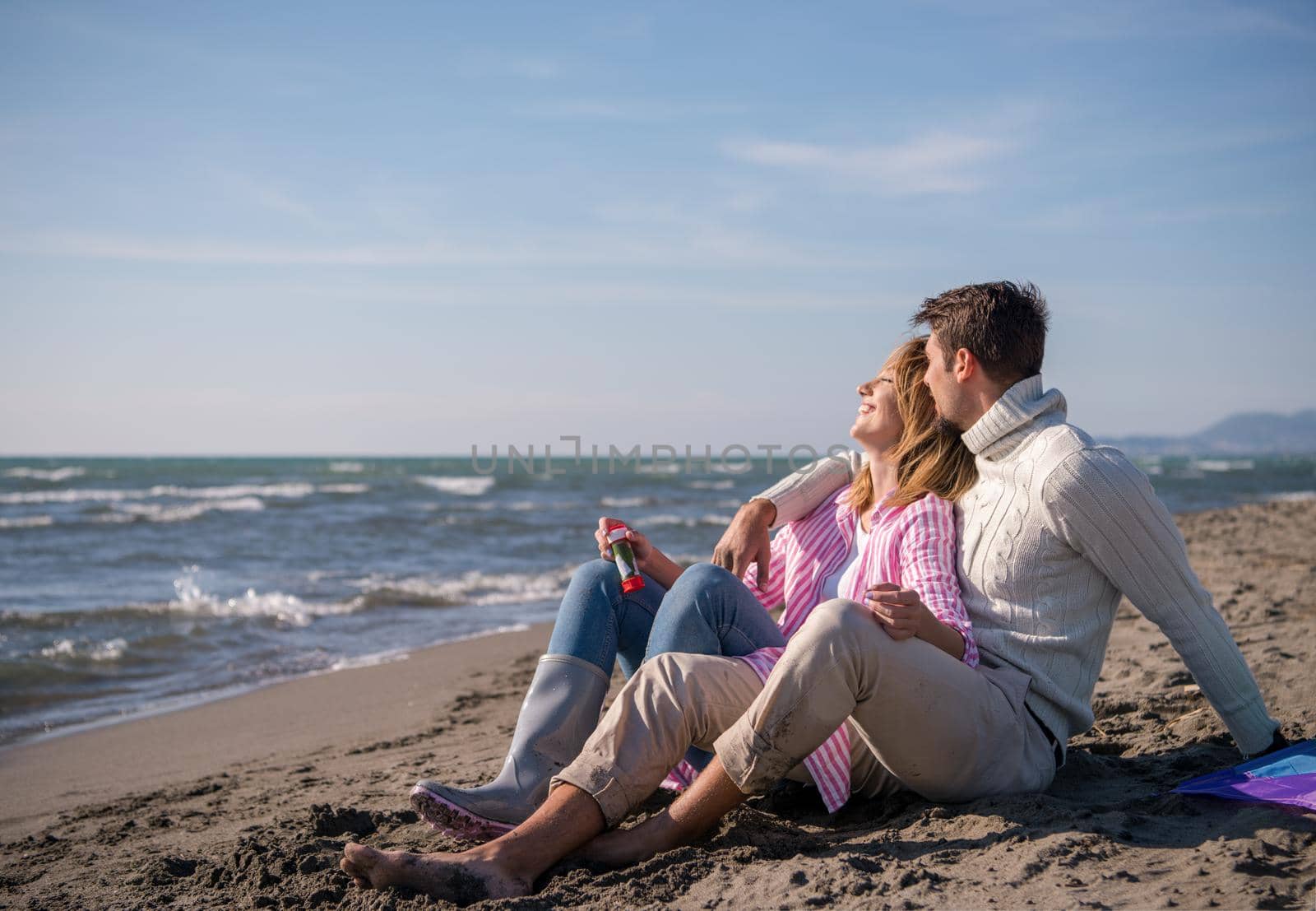 young couple enjoying time together at beach by dotshock