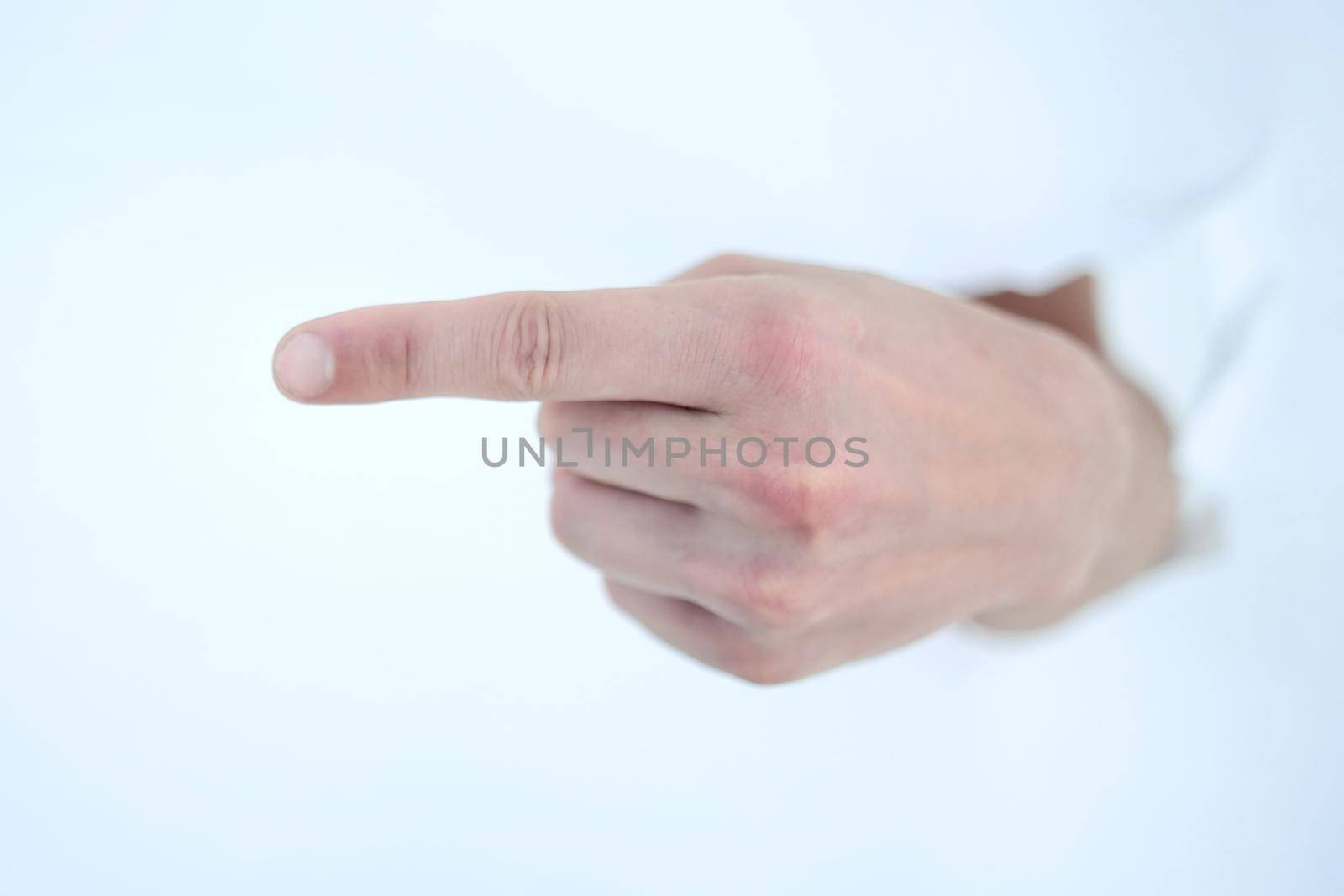 man's hand breaking through the paper wall and pointing at you .photo with copy space