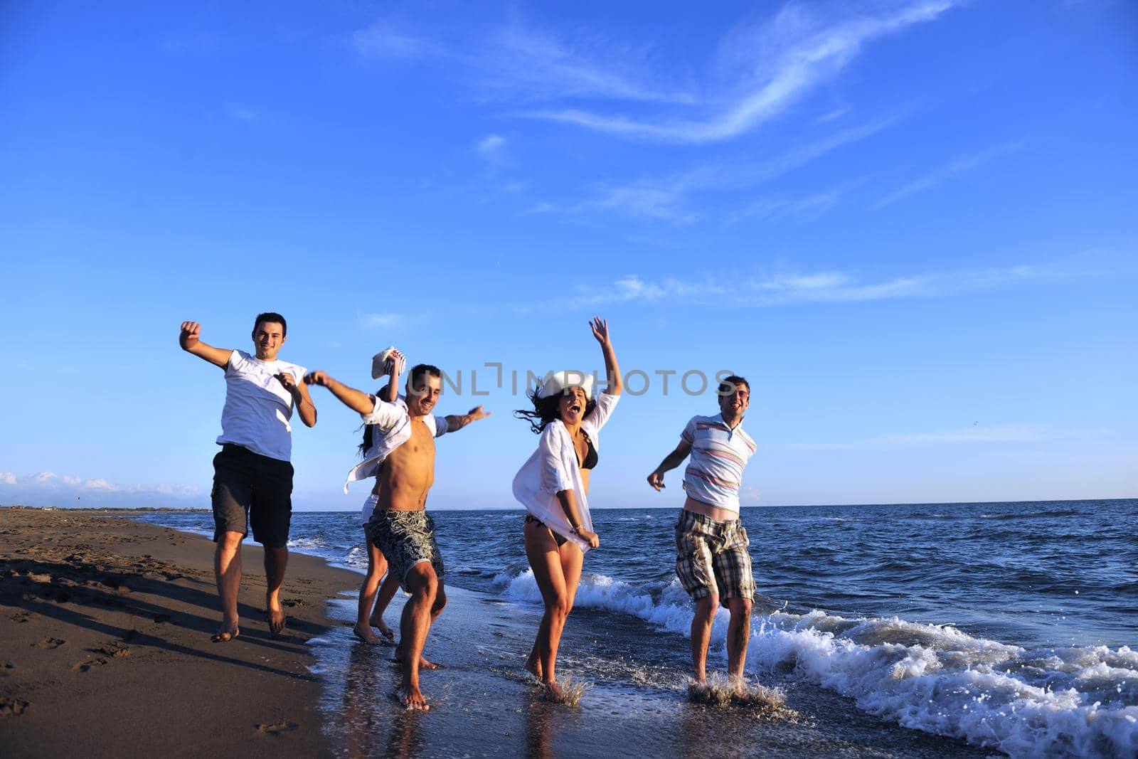 people group running on the beach by dotshock
