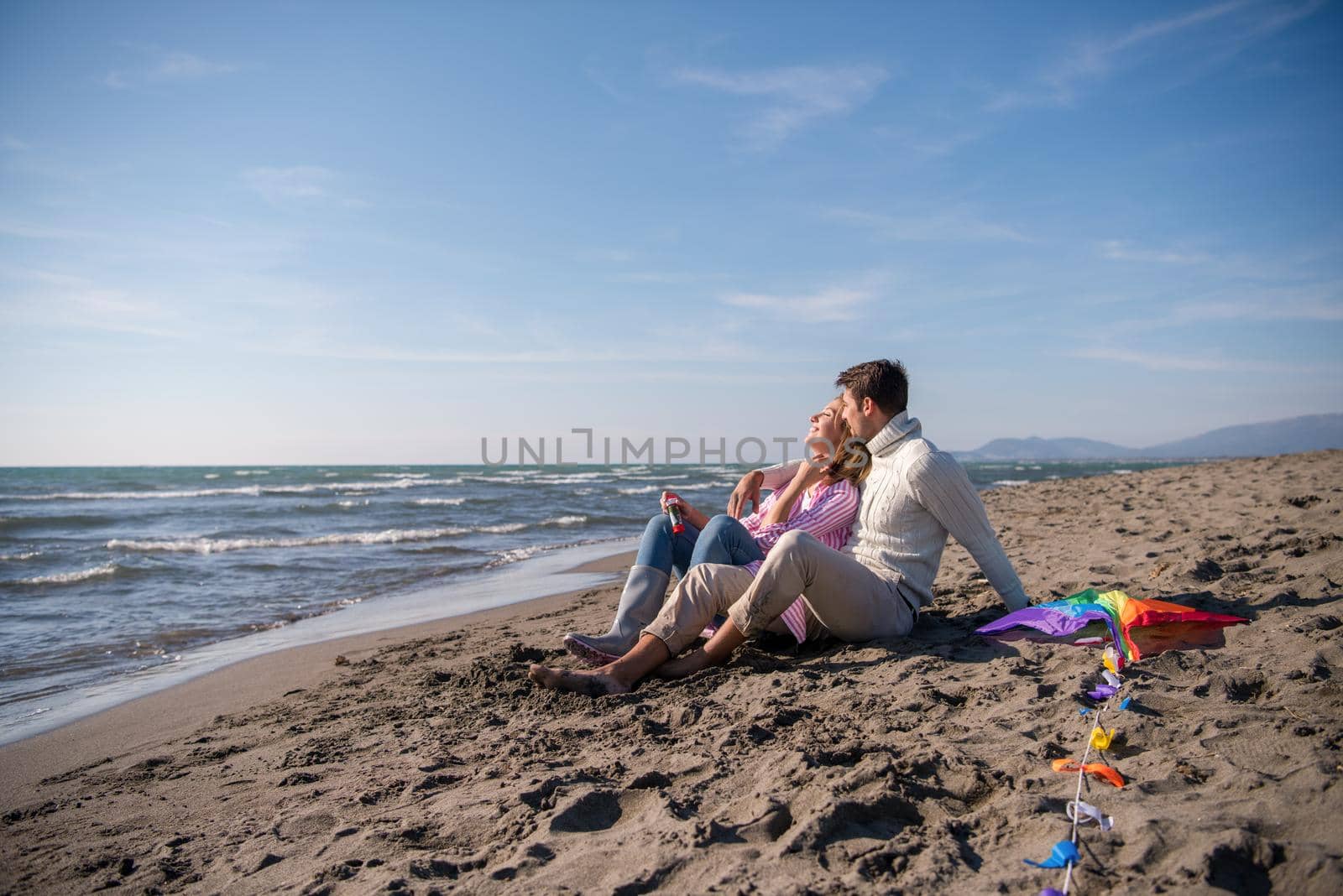 young couple enjoying time together at beach by dotshock