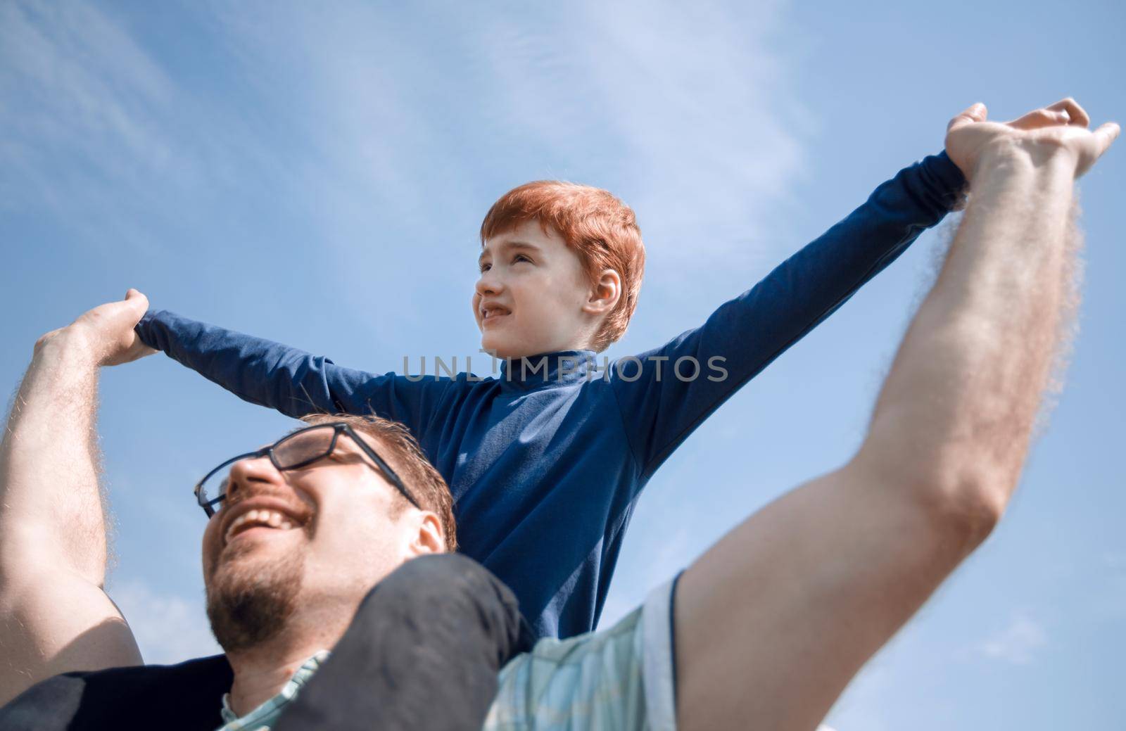 happy father has a little son on his shoulders.the concept of fatherhood