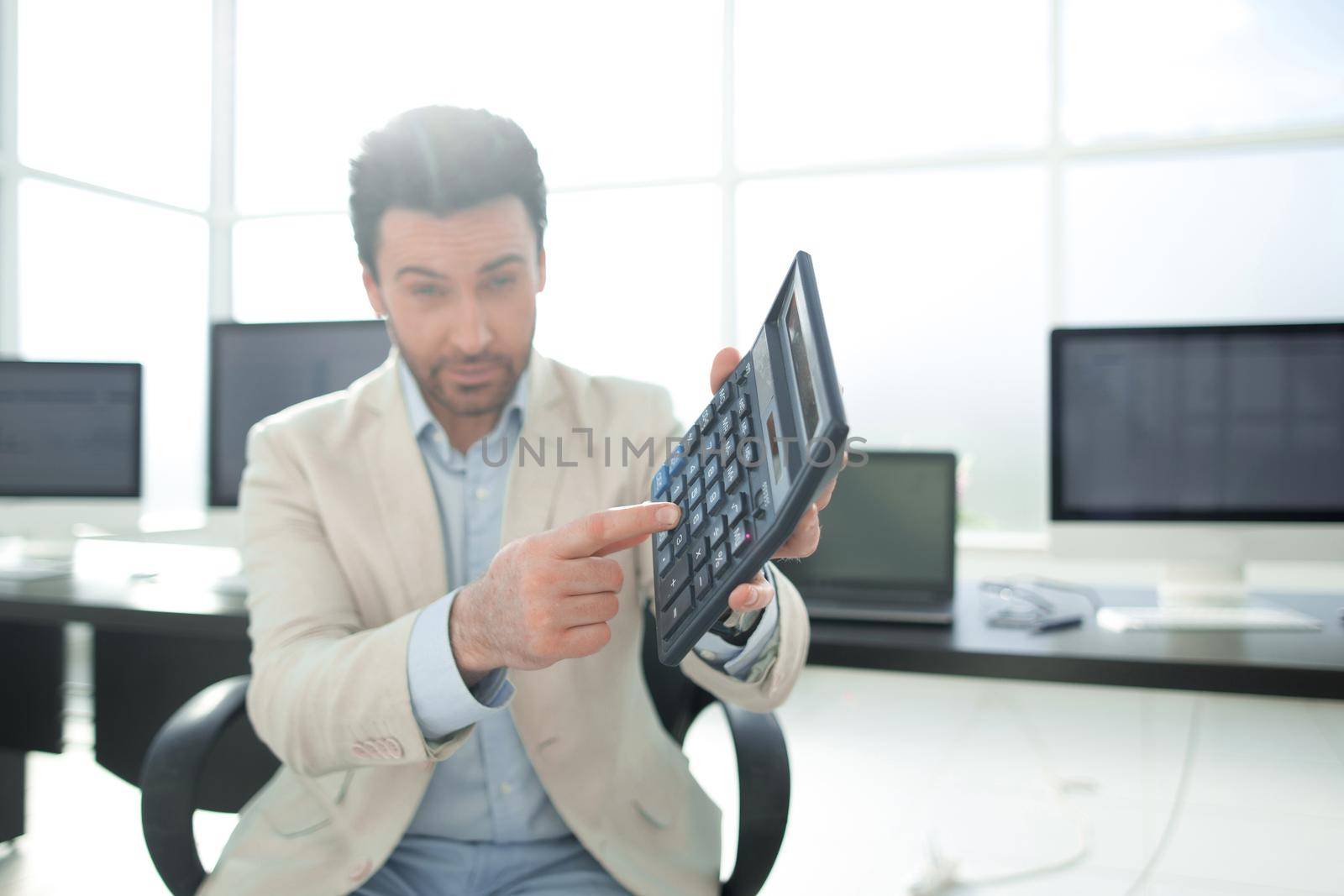 stylized photo.Businessman pointing to the calculator.photo with copy space