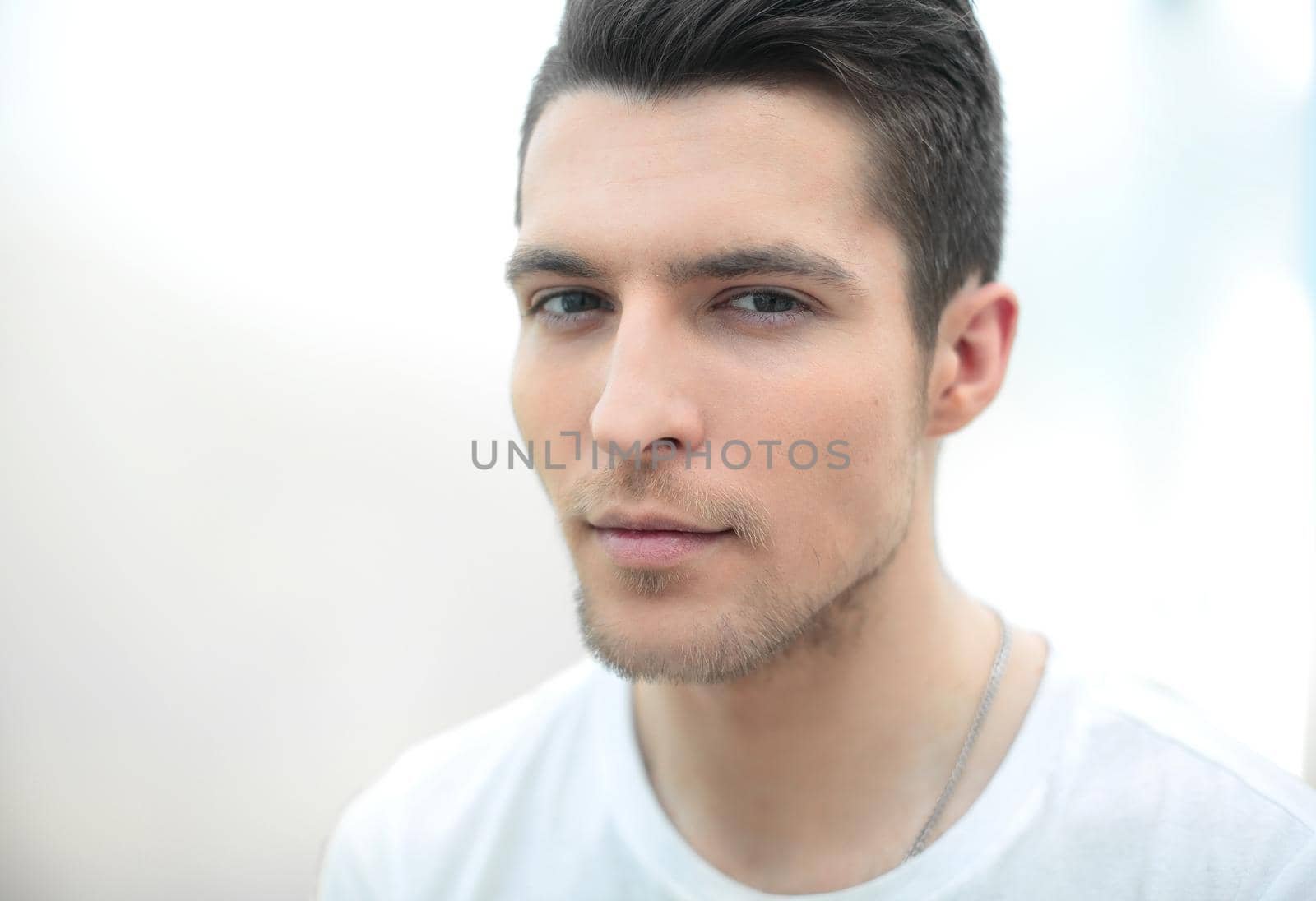 close up.Charming and handsome man on light background