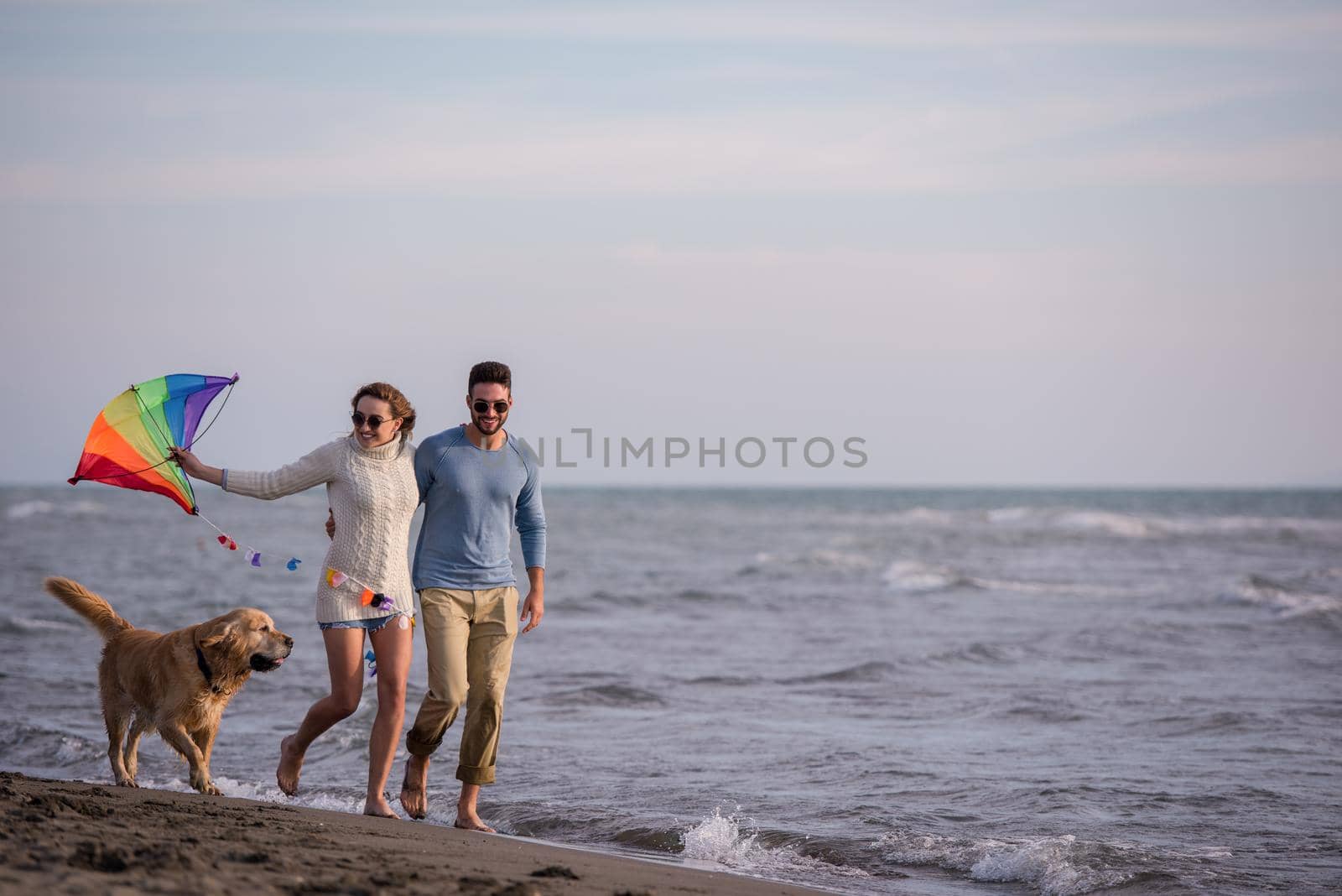 happy couple enjoying time together at beach by dotshock