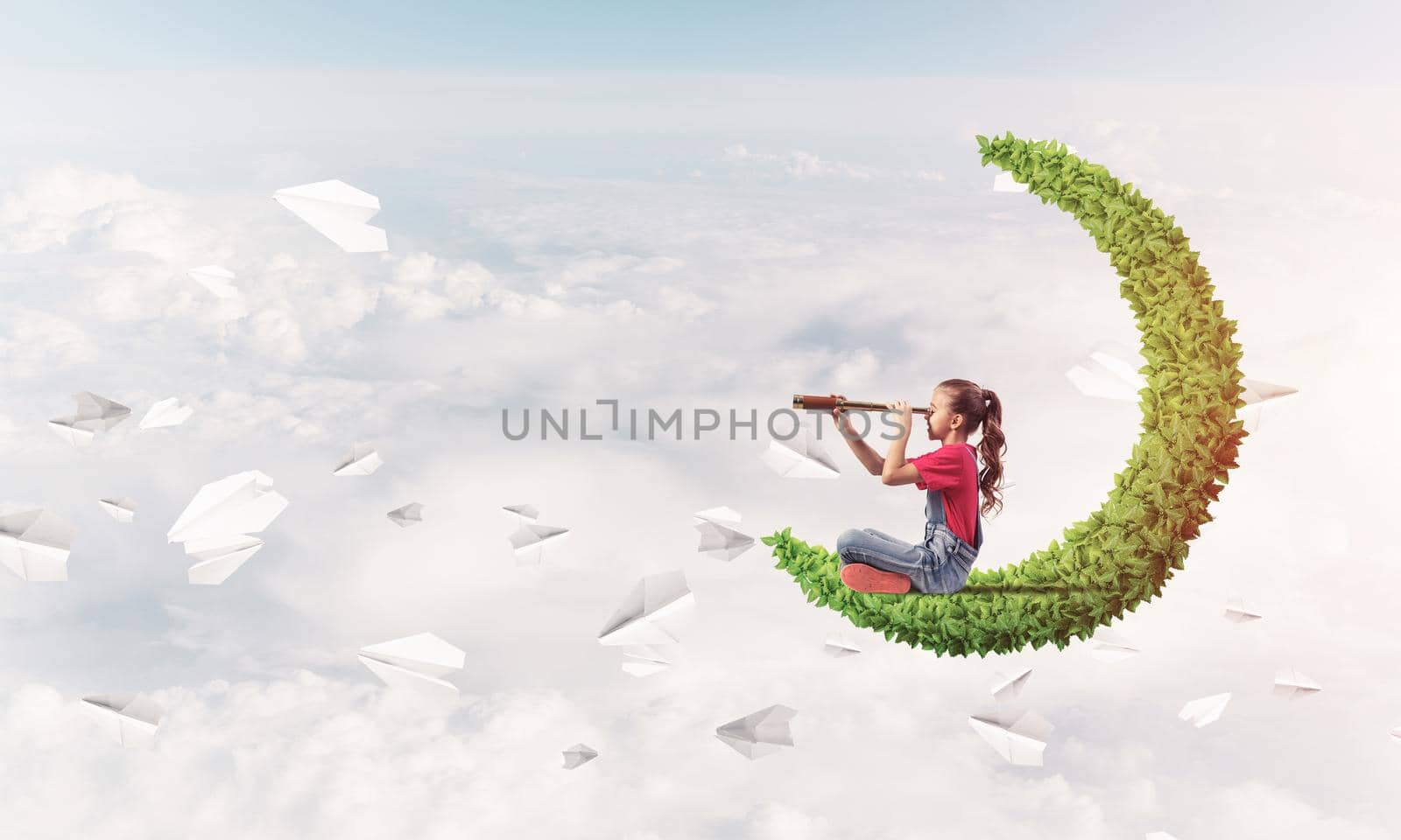 Cute kid girl on green moon in day sky looking in spyglass