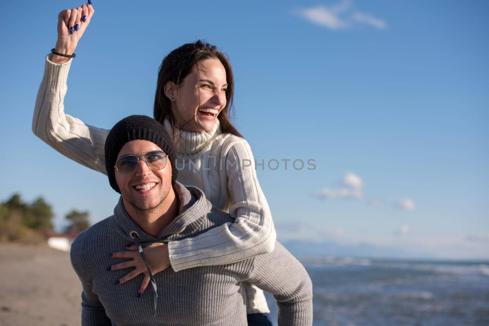 couple having fun at beach during autumn by dotshock
