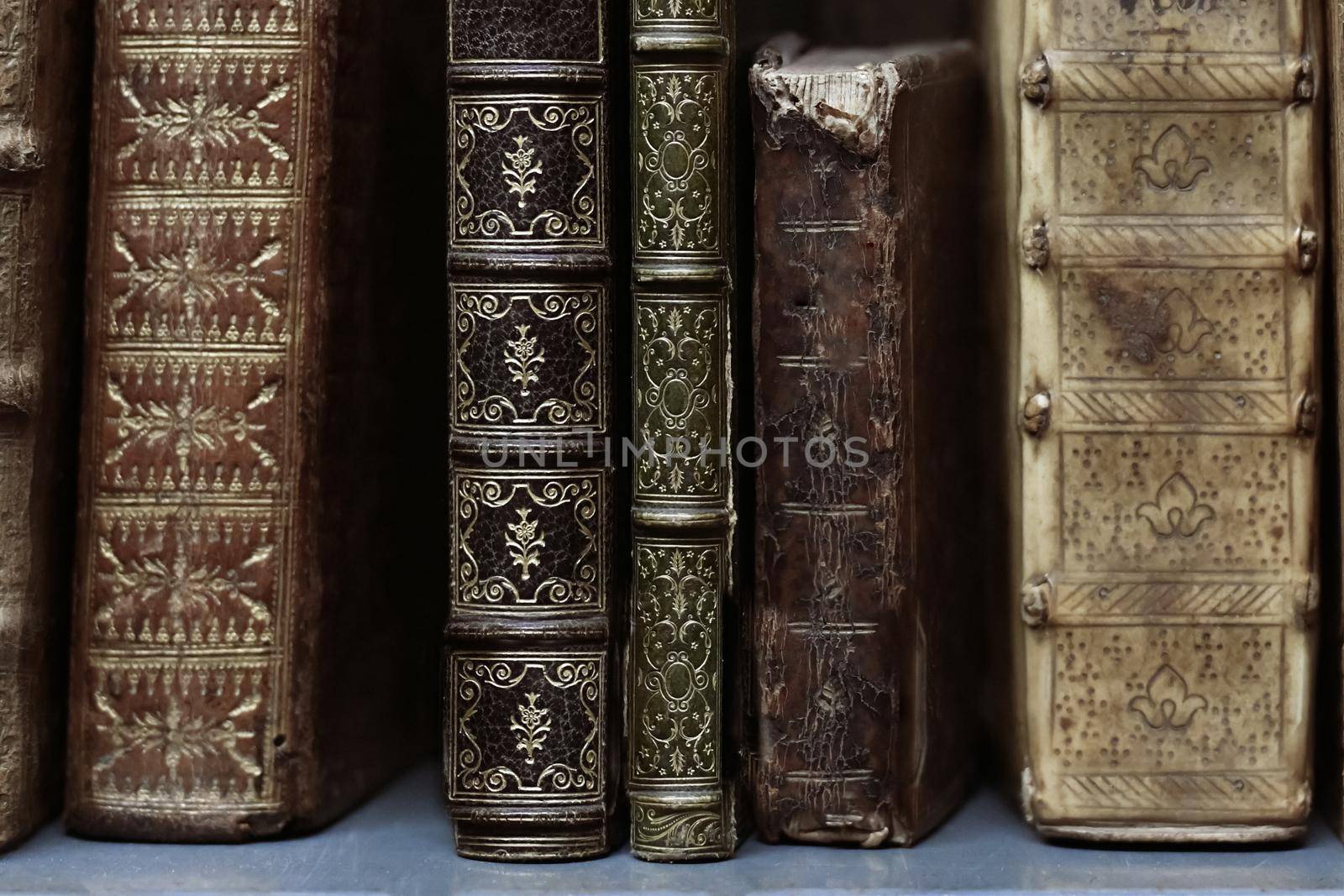 Old worn books on a shelf in the library's archives