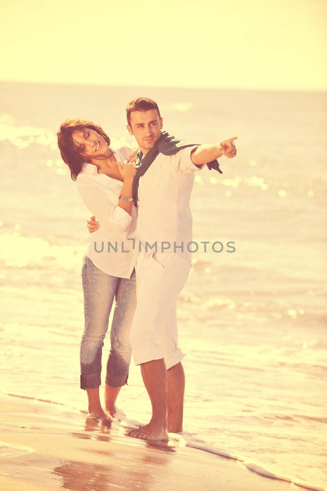 happy young couple have fun at beautiful beach by dotshock