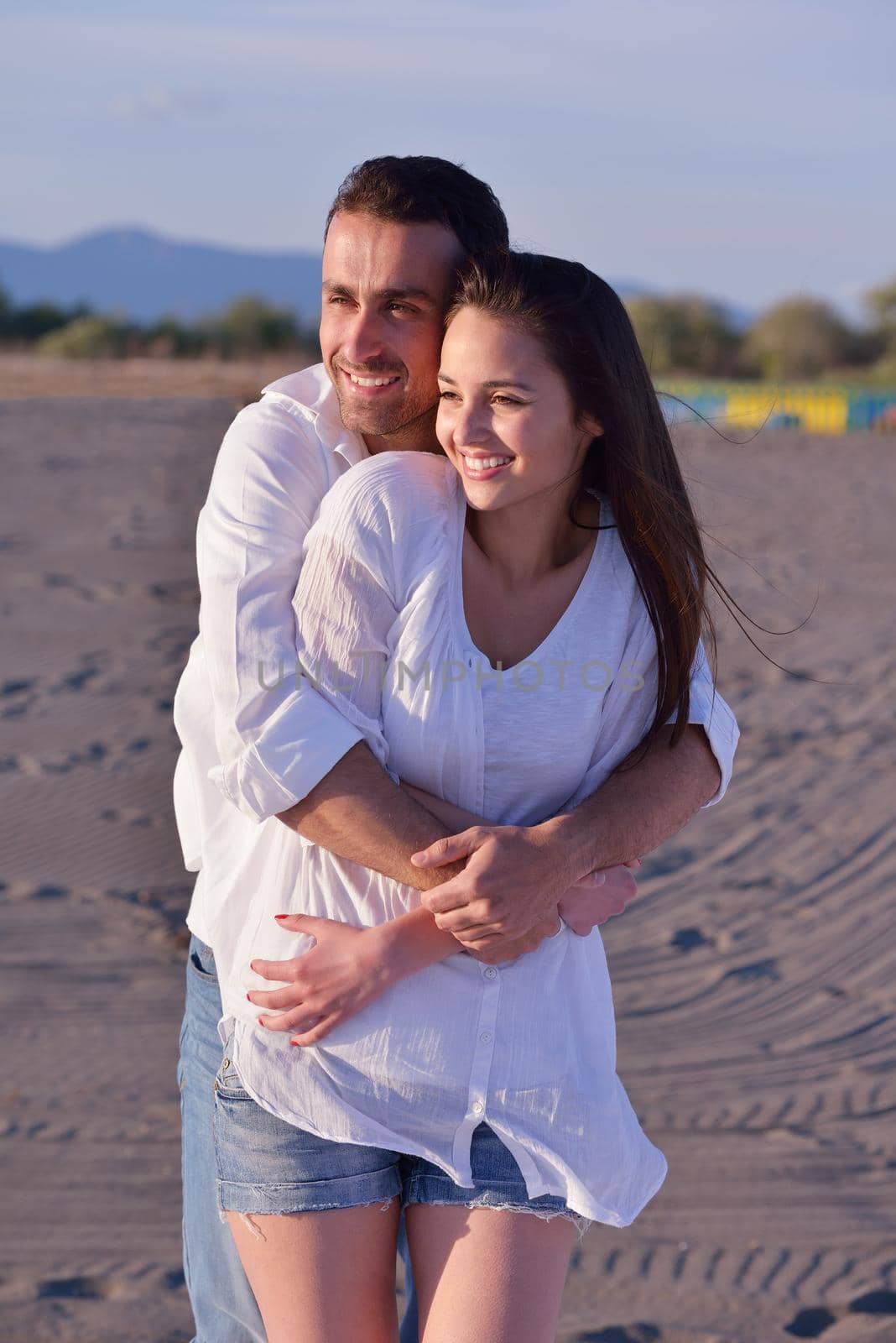 happy young romantic couple in love have fun on beautiful beach at beautiful summer day