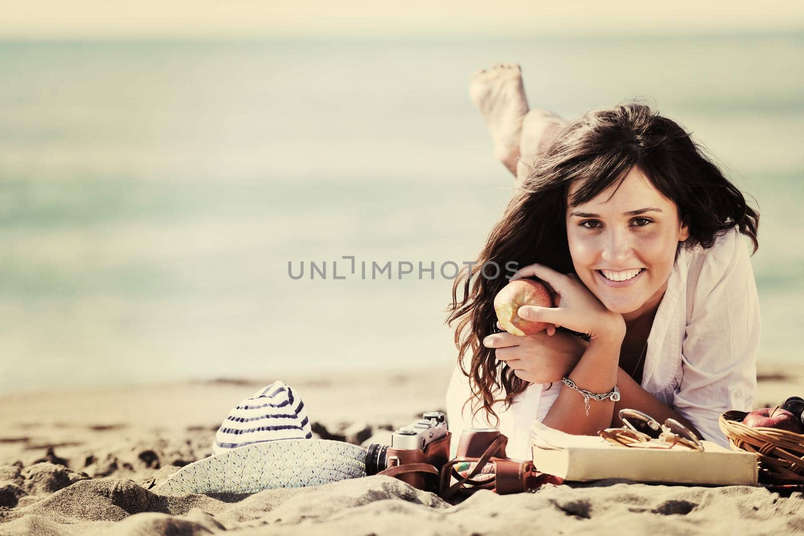 happy young woman on beach by dotshock