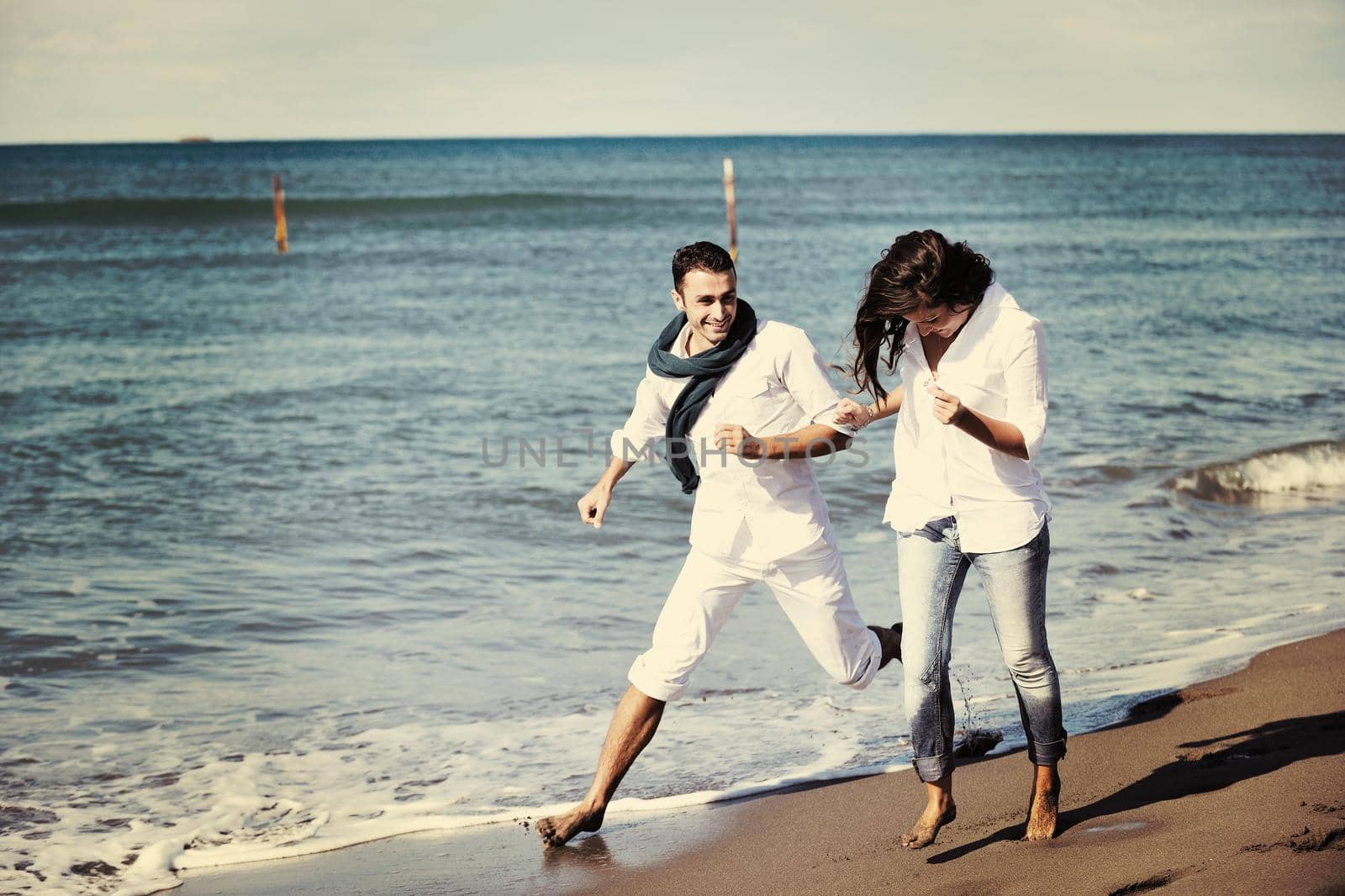 happy young couple in white clothing  have romantic recreation and   fun at beautiful beach on  vacations