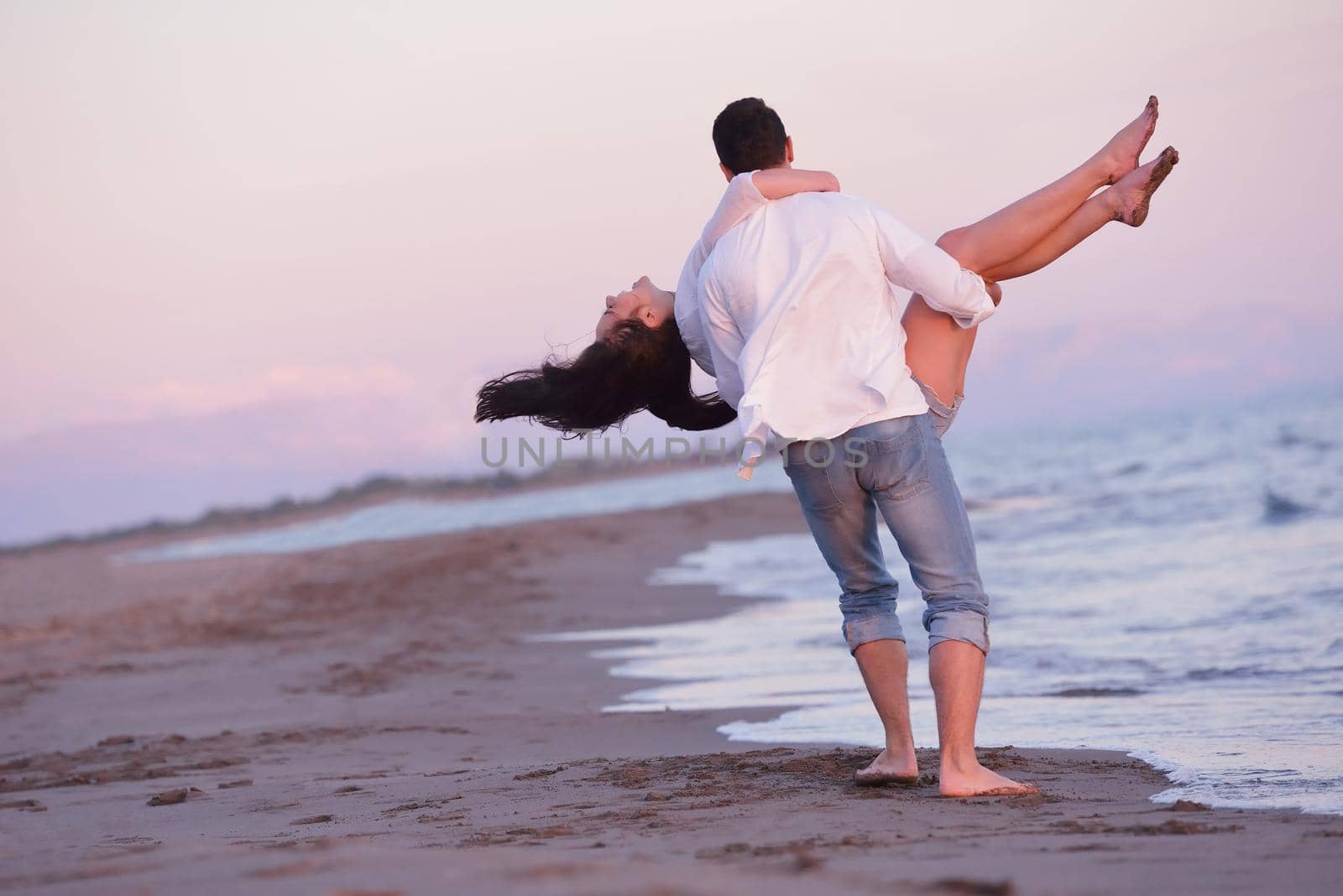 young couple  on beach have fun by dotshock