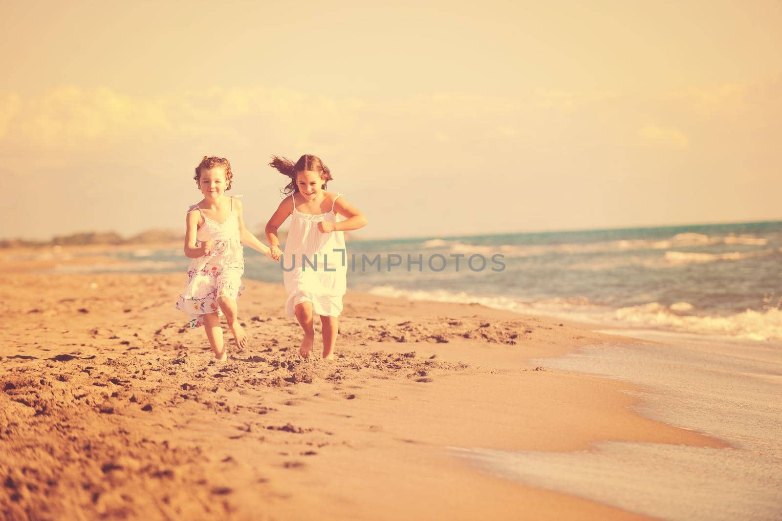 cute little girls running on beach by dotshock