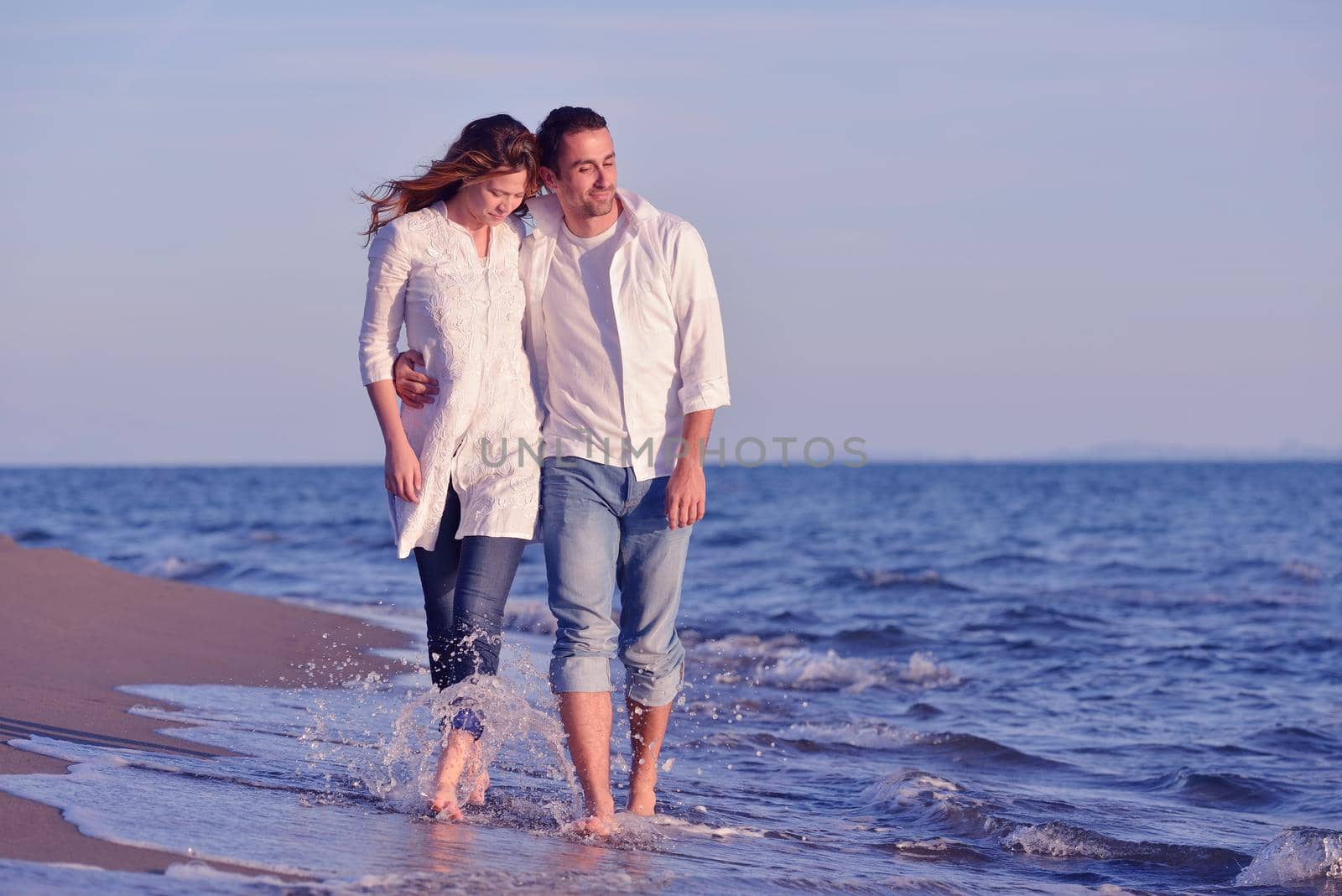 young couple  on beach have fun by dotshock