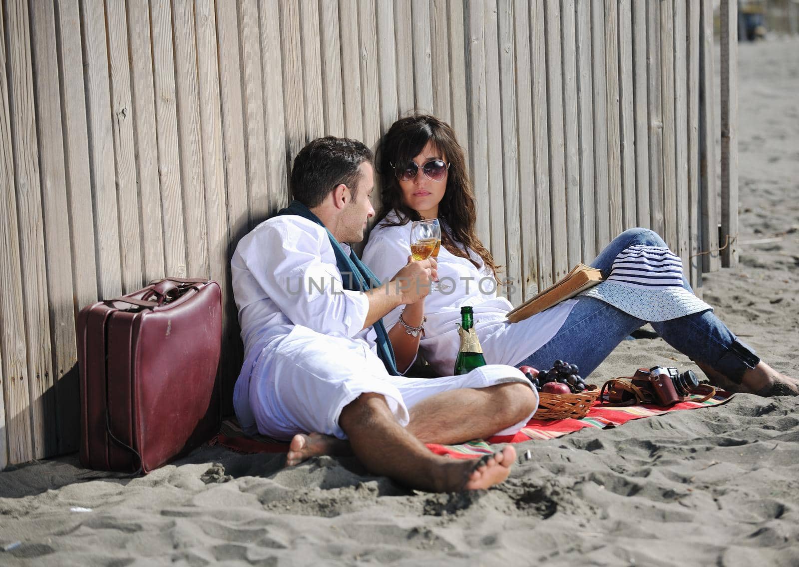 happy young couple enjoying  picnic on the beach and have good time on summer vacations