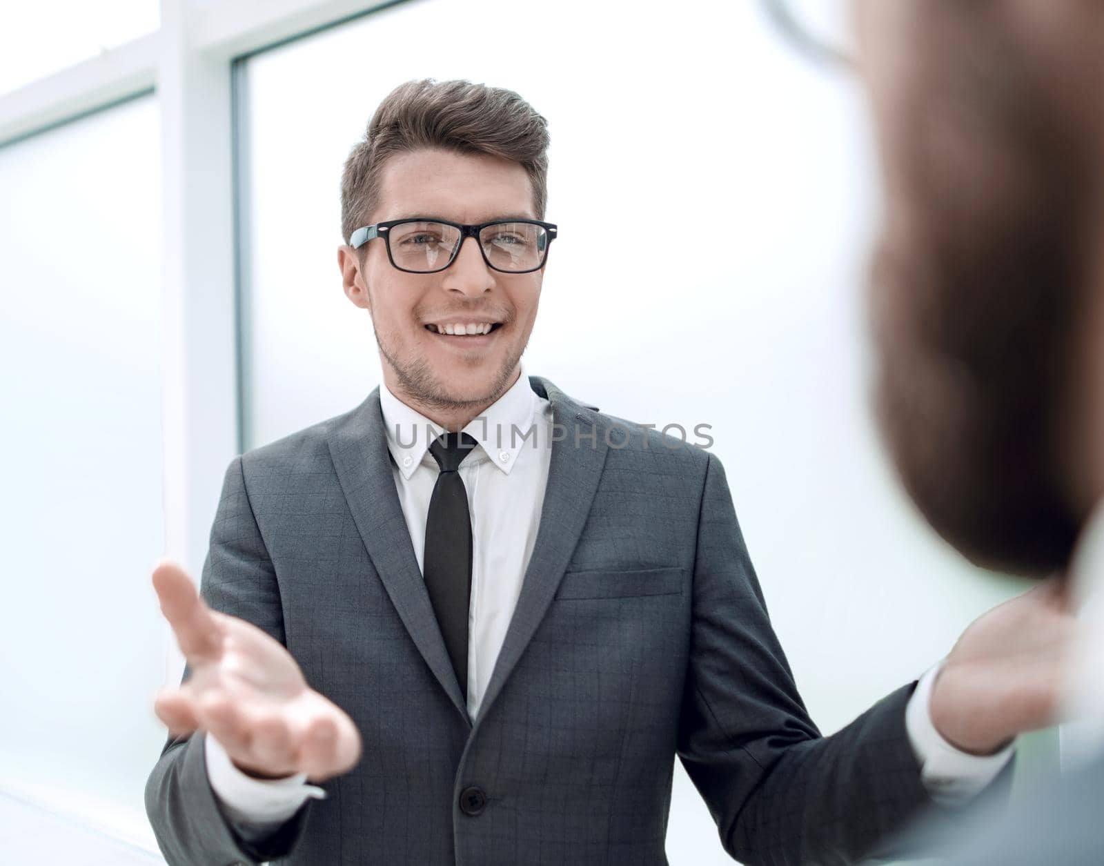 young businessman talking standing in the office.business concept