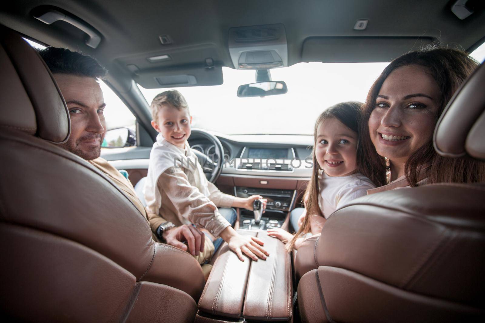 modern family sitting in a comfortable car by asdf