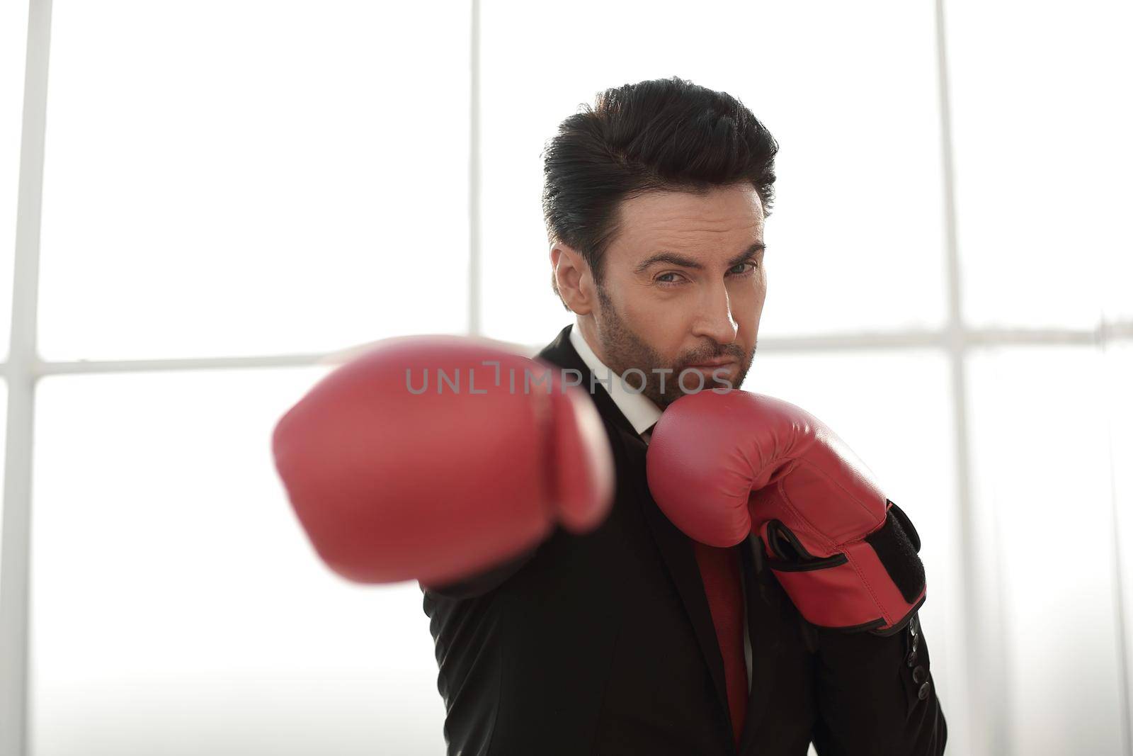 close up.confident businessman in Boxing gloves.photo with copy space