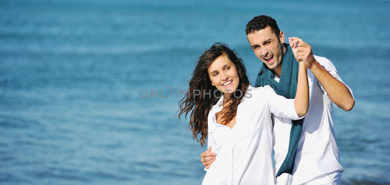 happy young couple in white clothing  have romantic recreation and   fun at beautiful beach on  vacations