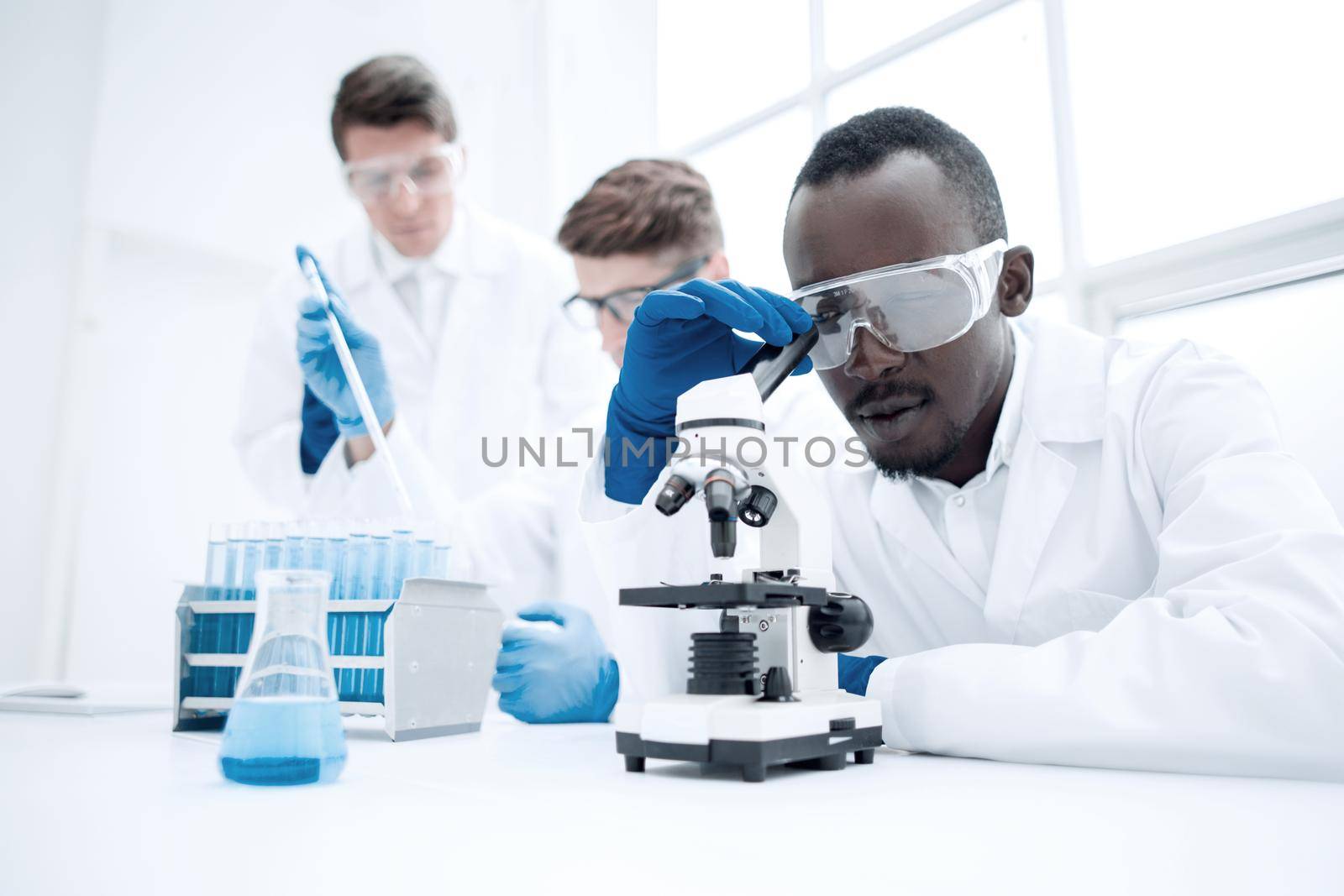 modern scientist looking through a microscope.photo with copy space