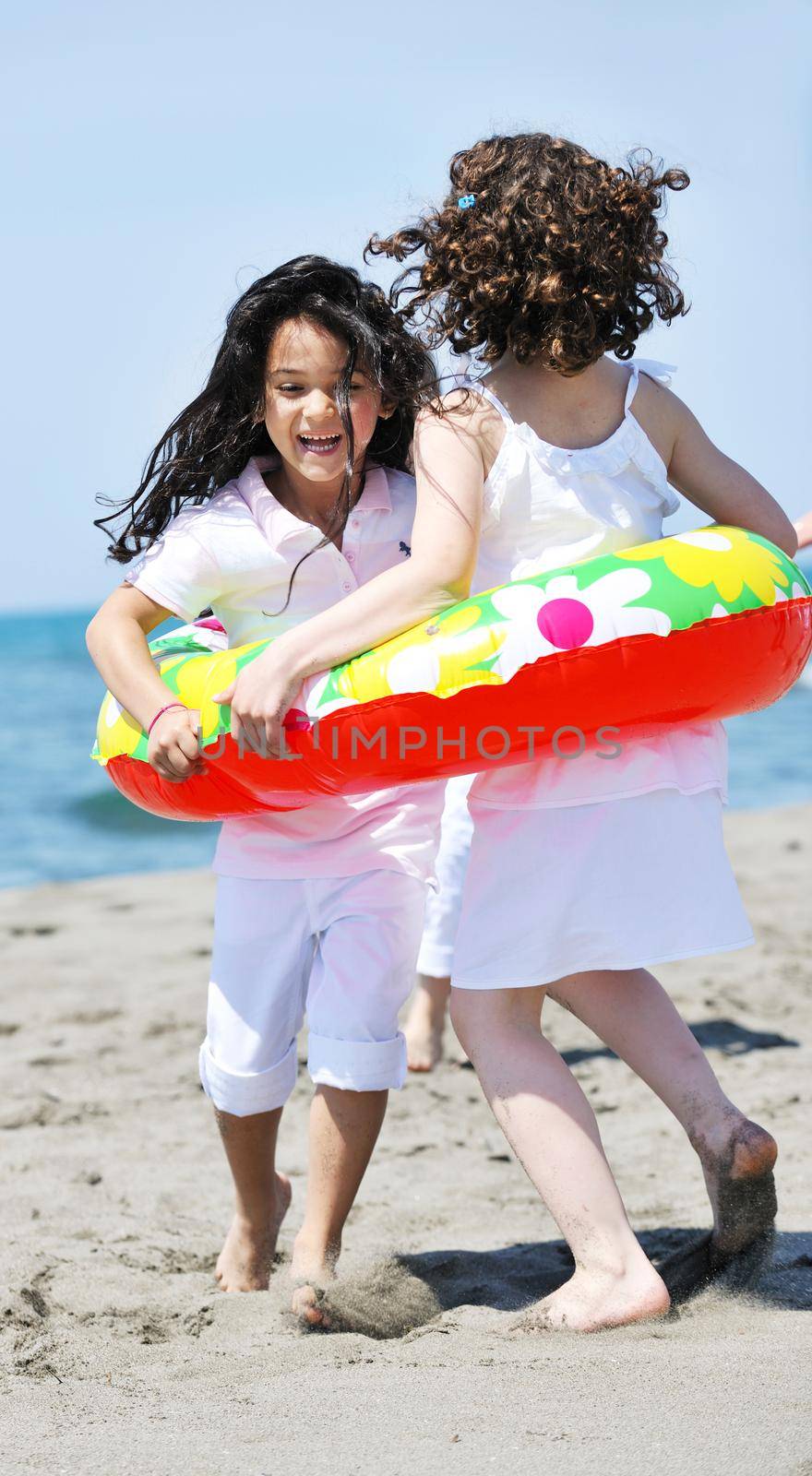 group of happy child on beach who have fun and play games