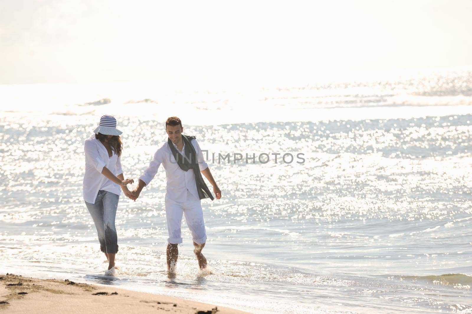 happy young couple have fun at beautiful beach by dotshock