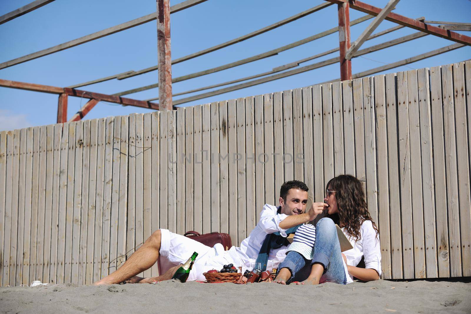 happy young couple enjoying  picnic on the beach and have good time on summer vacations