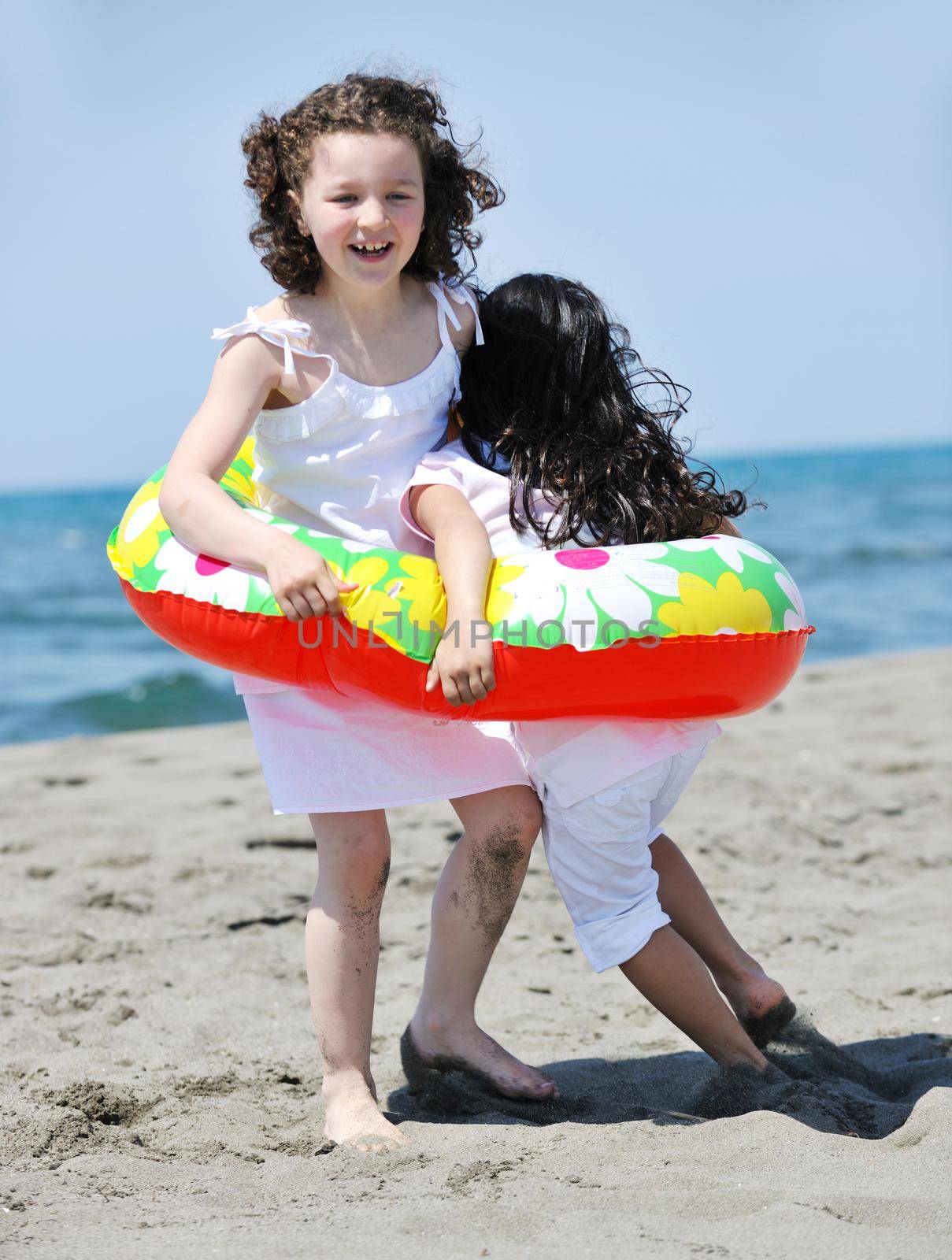 group of happy child on beach who have fun and play games